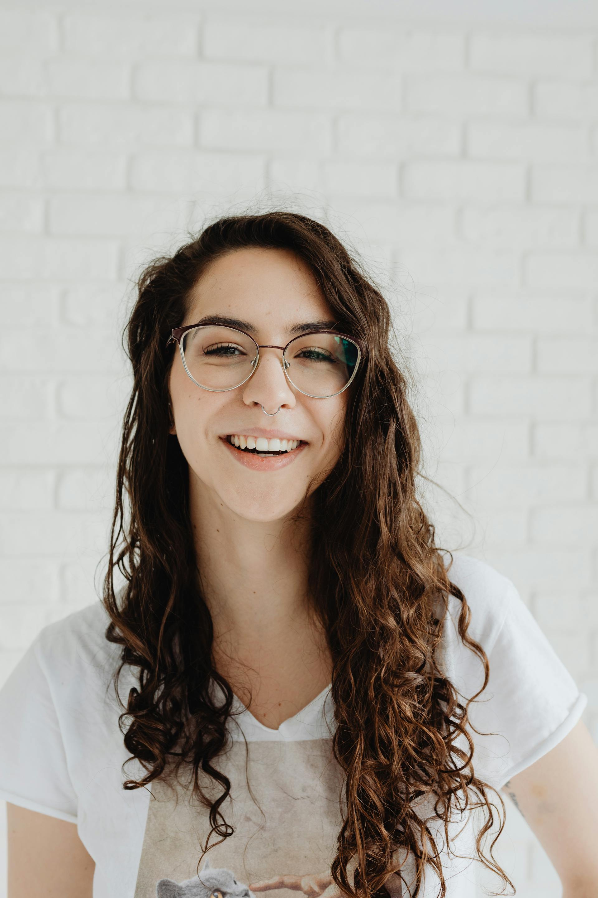 A smiling woman wearing eyeglasses | Source: Pexels