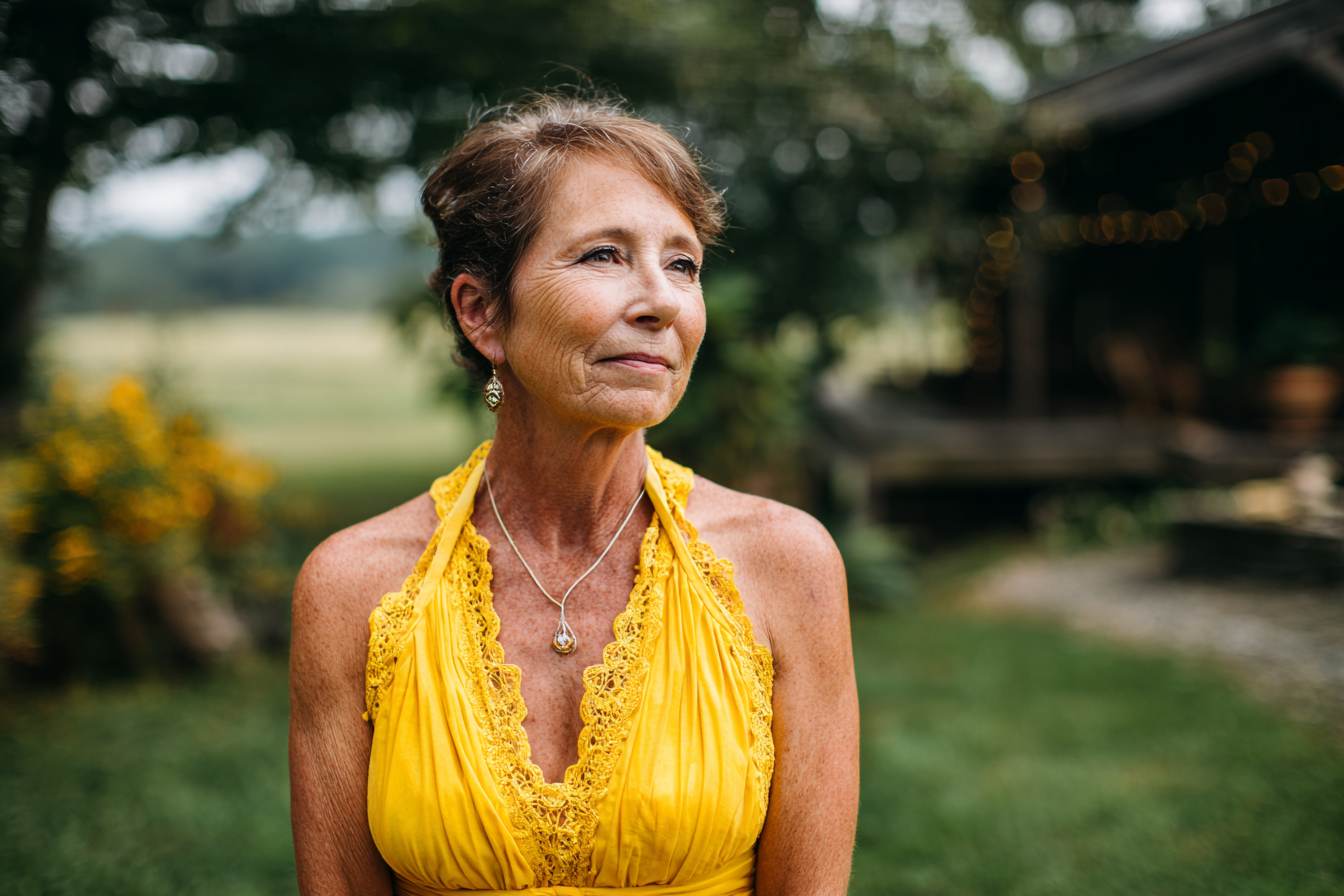An older woman in a yellow sundress | Source: Midjourney
