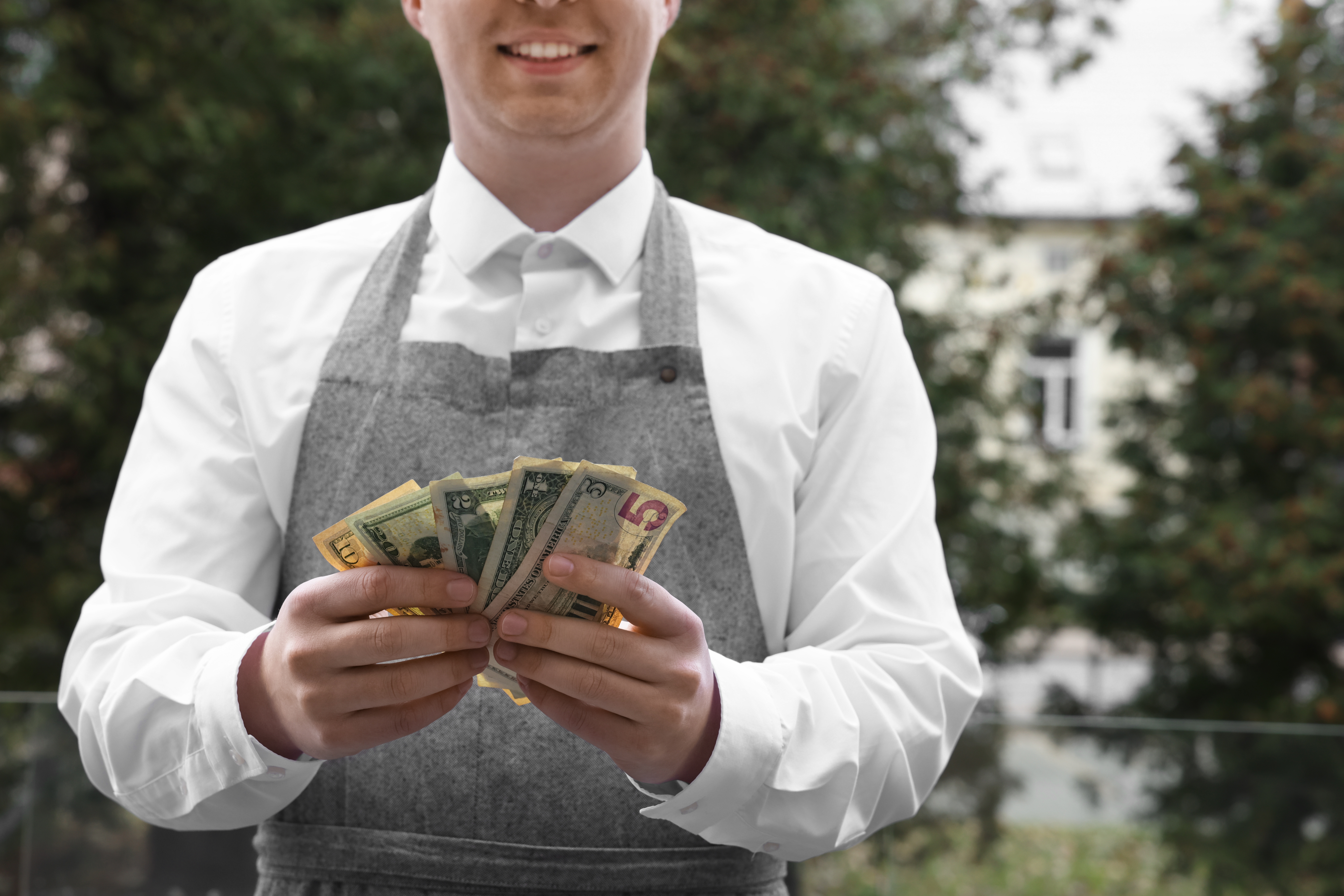 Waiter with tips | Source: Shutterstock
