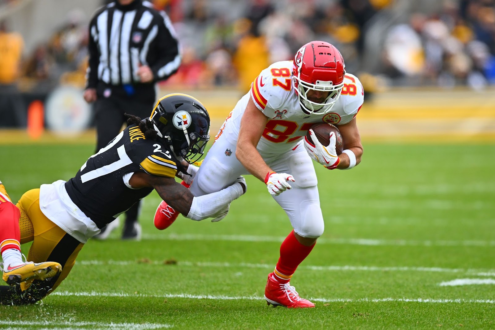 Travis Kelce, #87 of the Kansas City Chiefs, tackled by Cory Trice Jr., #27 of the Pittsburgh Steelers, during the second quarter at Acrisure Stadium on December 25, 2024, in Pittsburgh, Pennsylvania. | Source: Getty Images