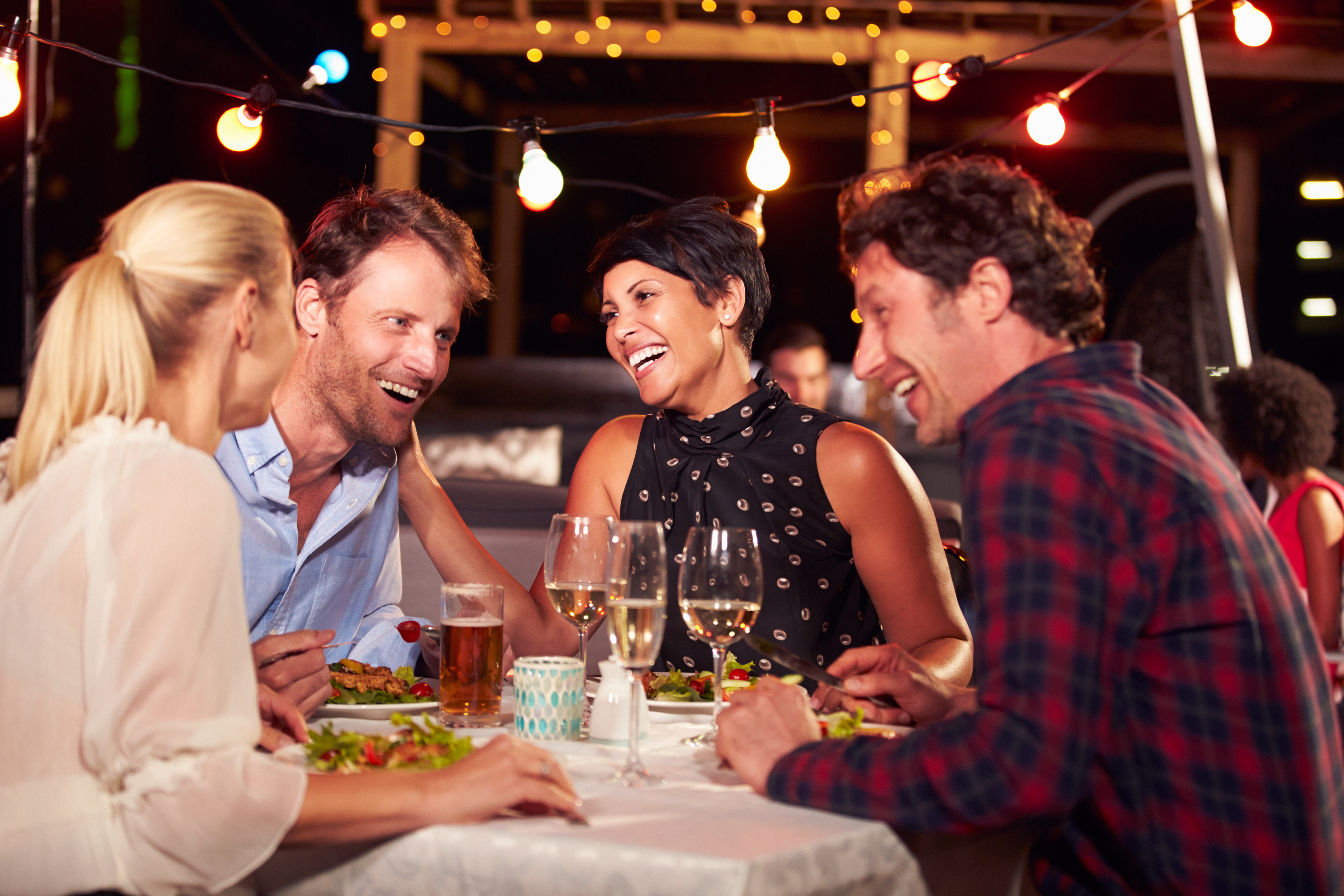 Friends enjoying a meal | Source: Shutterstock