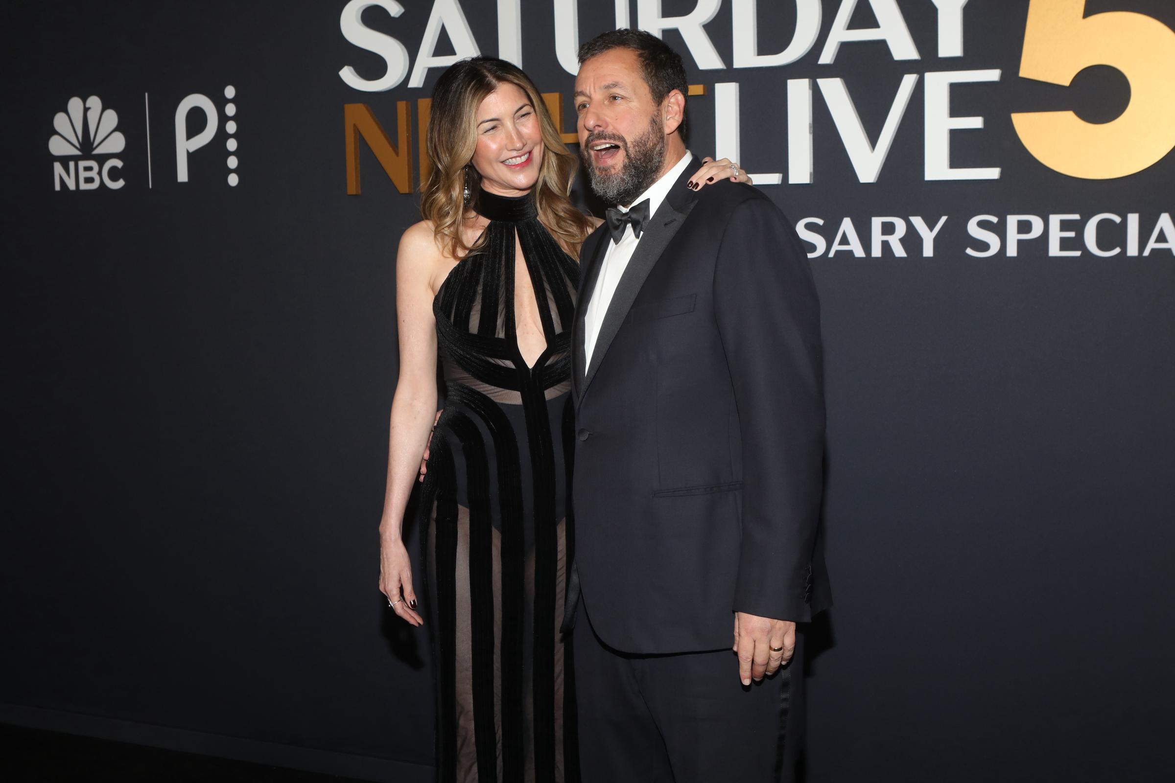 Jackie Sandler and Adam Sandler candidly pose for the cameras at the "SNL50: The Anniversary Special" at 30 Rockefeller Plaza on February 16, 2025, in New York | Source: Getty Images