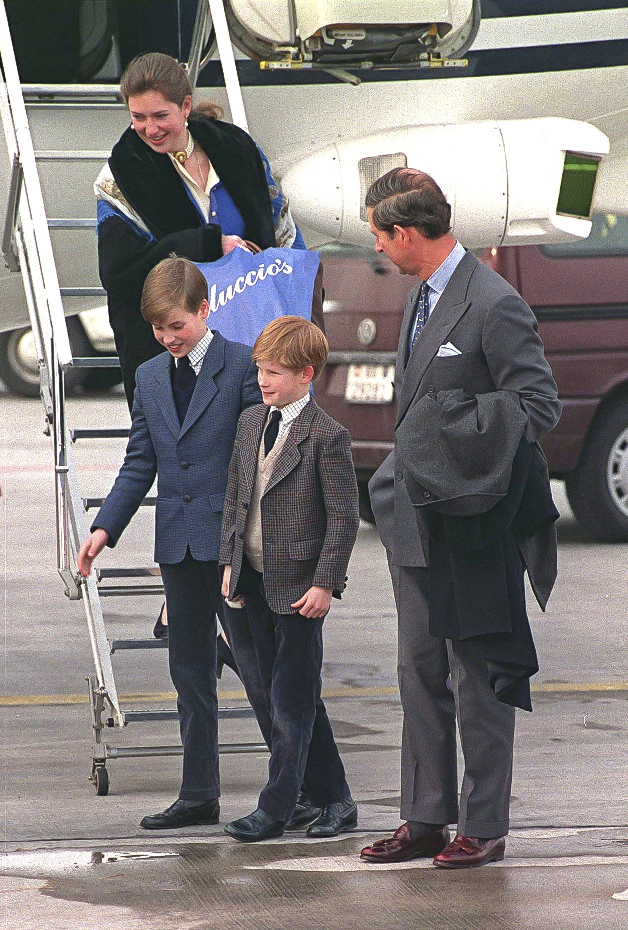 Prince Charles and Prince Harry standing with father Princes Charles and their Royal Nanny Tiggy Legge-Bourke at the Zurich Airport on February 17, 1994 | Photo: Getty Images