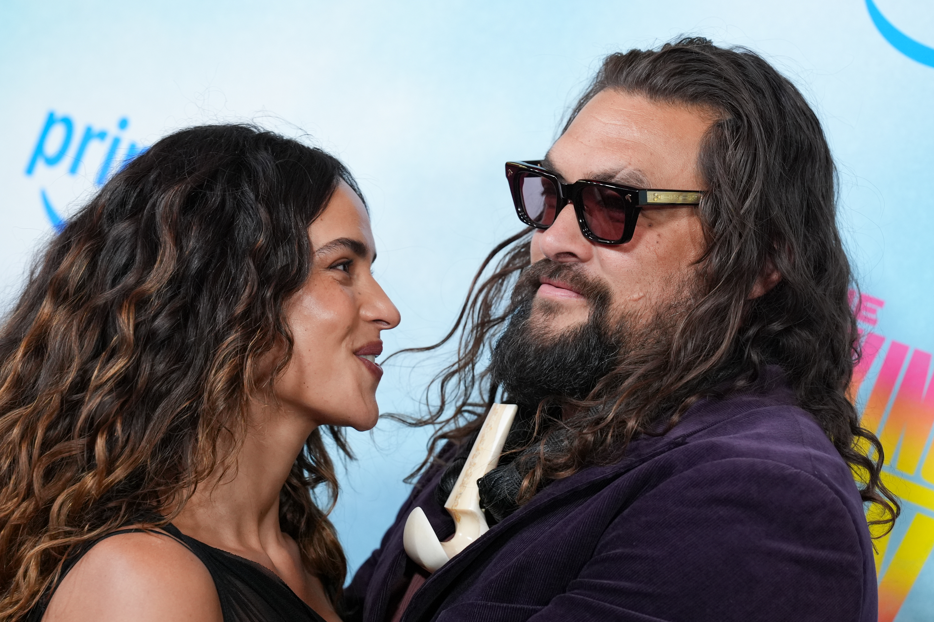 Jason Momoa and Adria Arjona share a close moment in a photo taken after they went public with their relationship. The pair's appearances together have repeatedly prompted comparisons between the actress and Momoa's ex-wife, Lisa Bonet. | Source: Getty Images