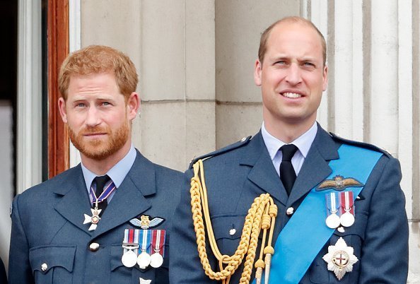 Prince Harry, Duke of Sussex and Prince William, Duke of Cambridge watch a flypast to mark the centenary of the Royal Air Force from the balcony of Buckingham Palace | Photo: Getty Images