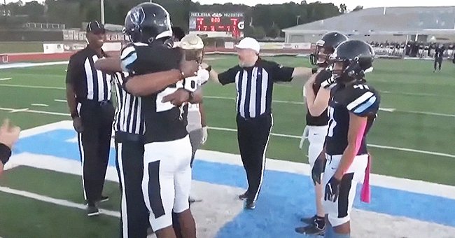Fred Grooms III hugging his father who surprised him at his football game. | Photo: YouTube.com/NBC News