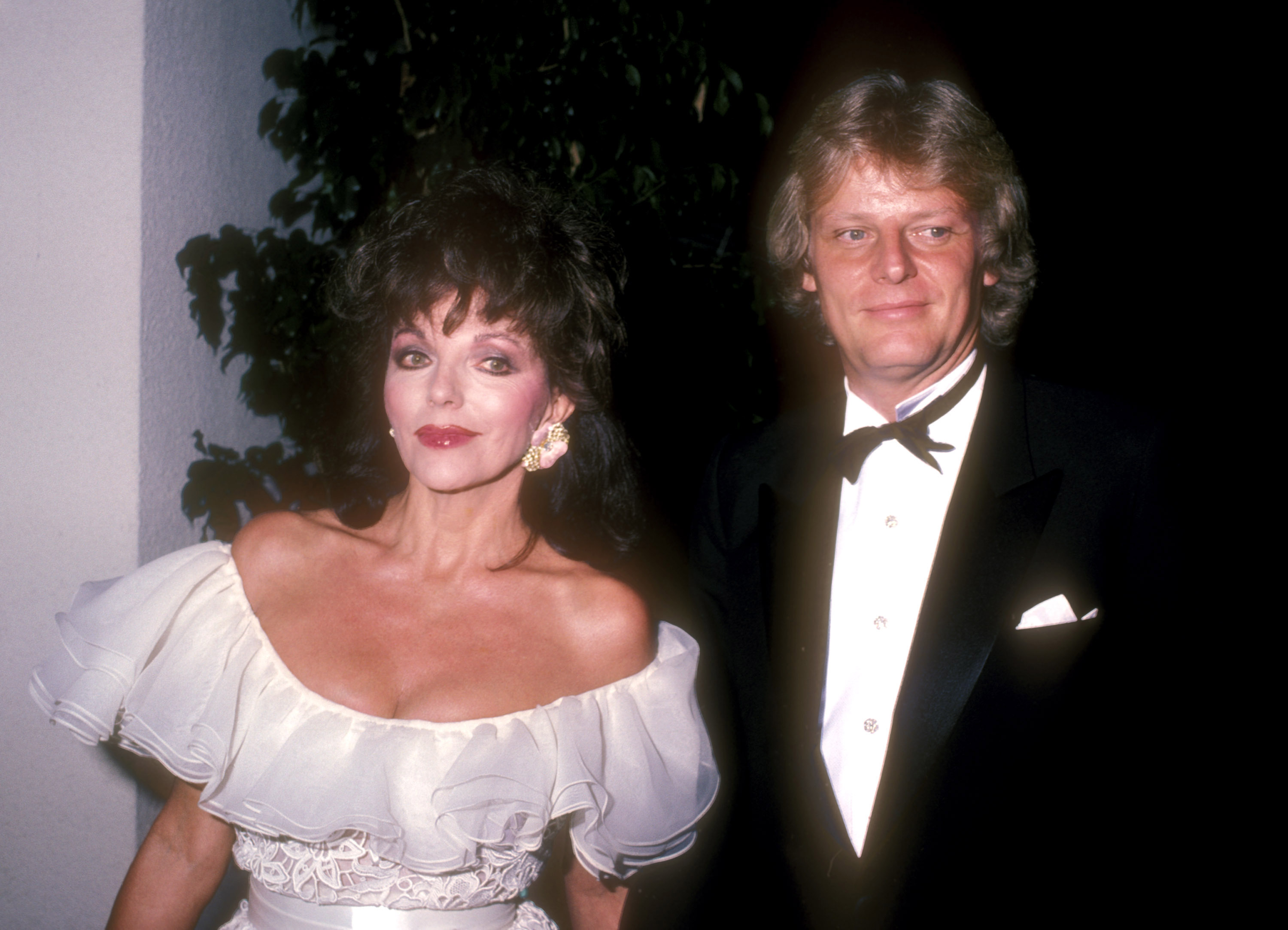 Joan Collins and Peter Holm (The Swede) during Nolan Miller's party on August 24, 1985  in California | Source: Getty Images