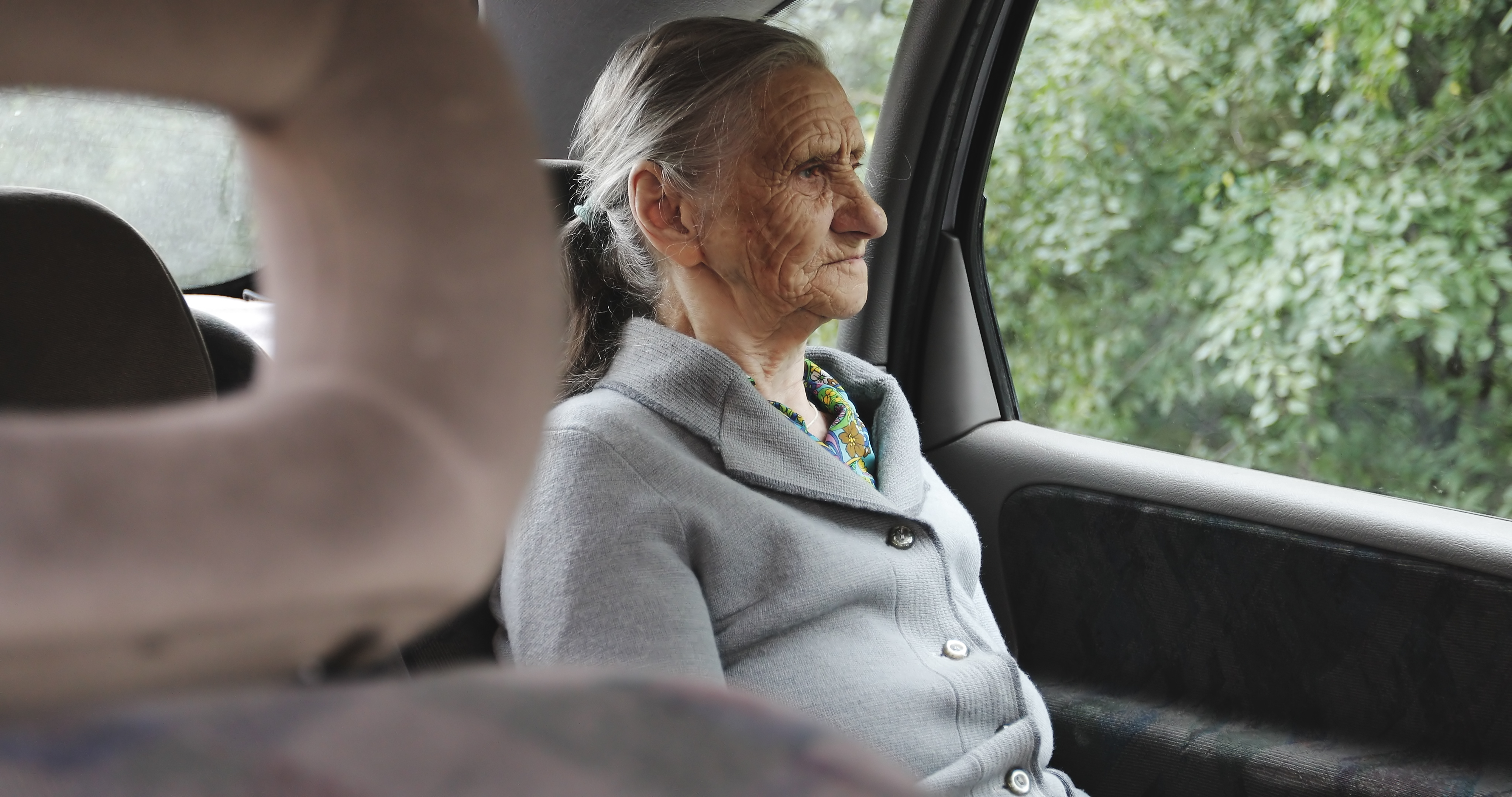 Older woman sitting by the car window | Source: Shutterstock