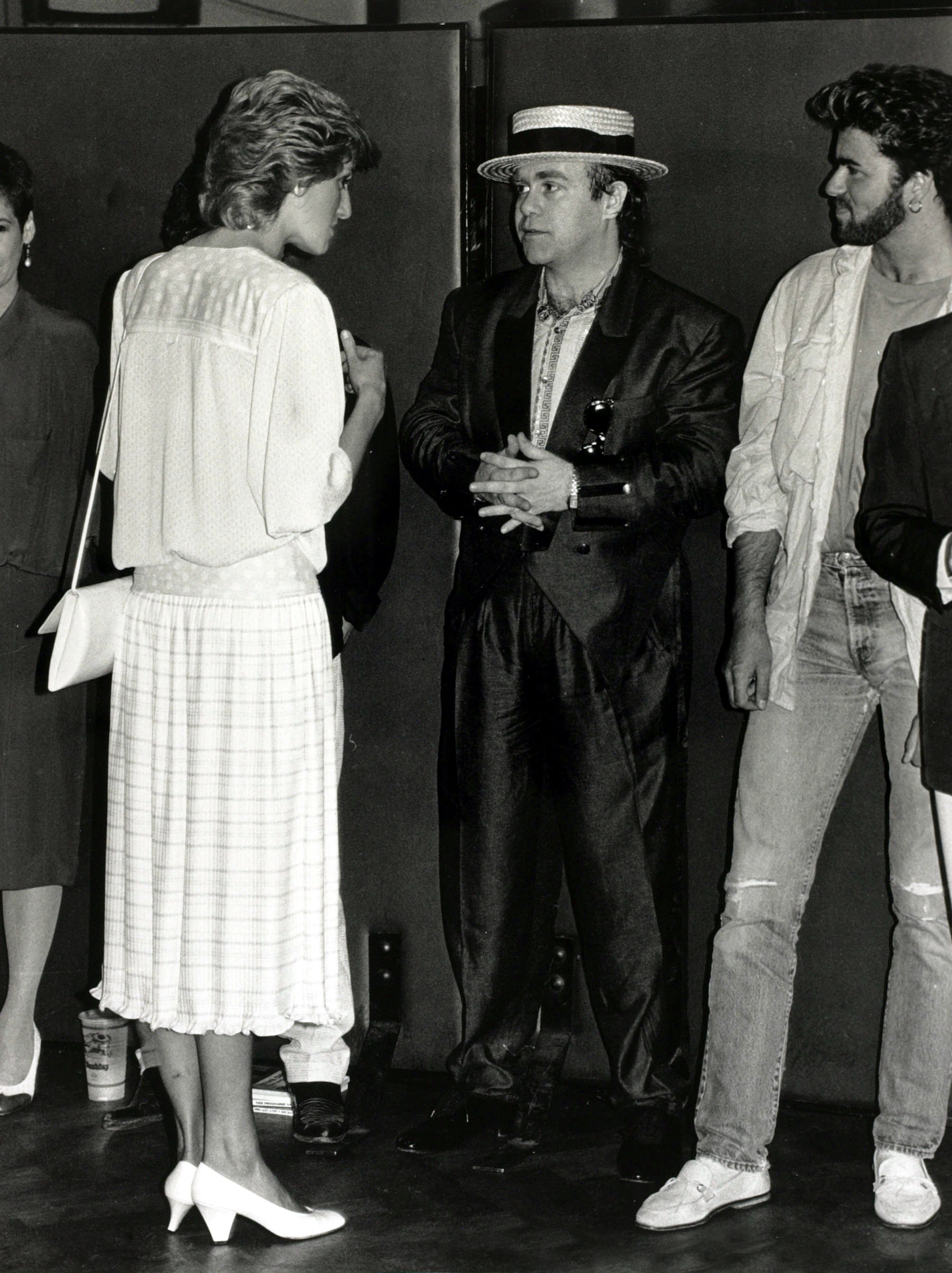 Diana, Princess of Wales pictured chatting to musicians Elton John and George Michael at the "Feed the World" Live Aid concert on13th July 1985, at Wembley | Source: Getty Images