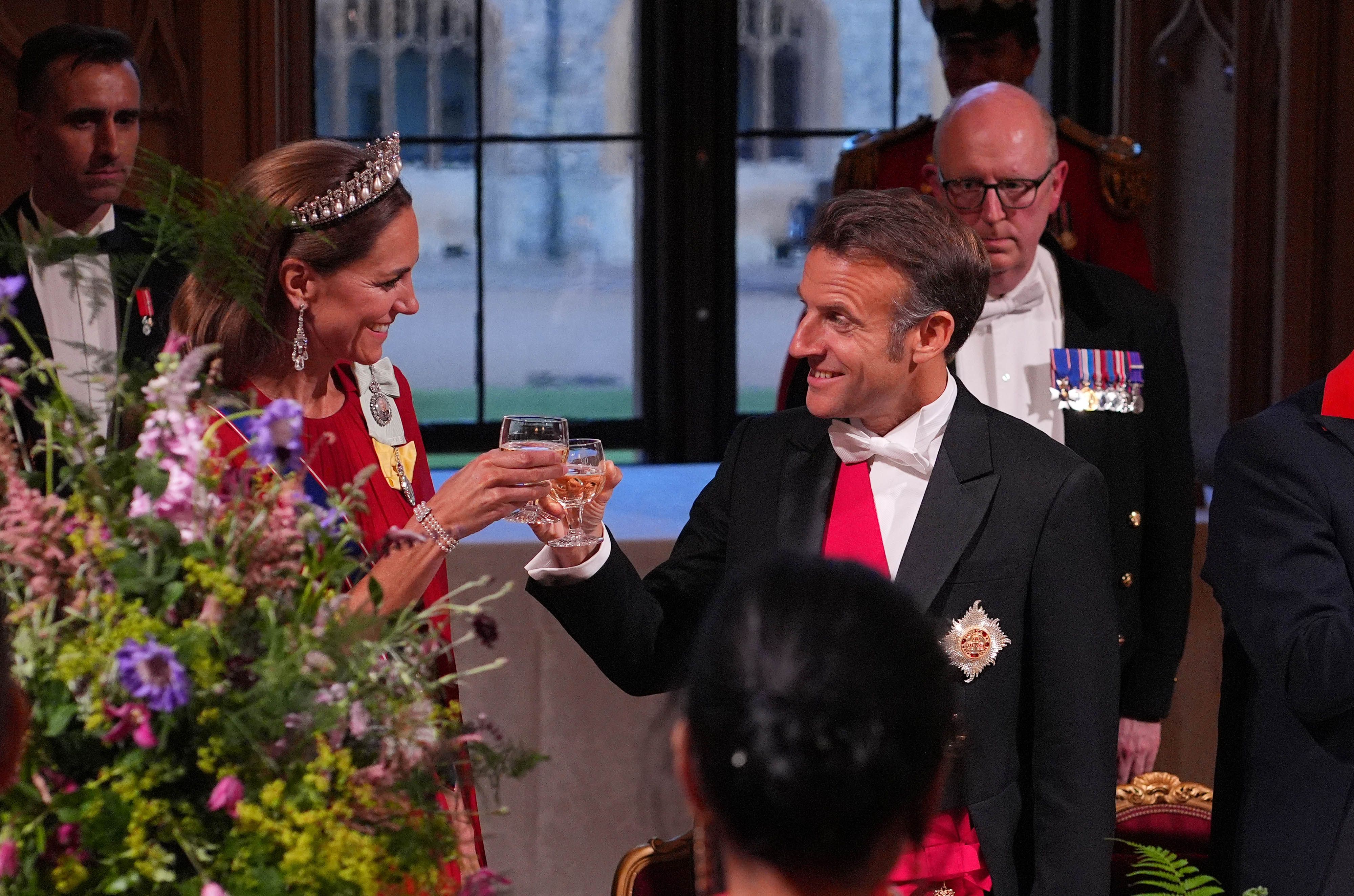 President Emmanuel Macron clinks glasses with a radiant Princess Catherine during the state banquet hosted by the British royal family in honor of the French delegation at Windsor Castle.