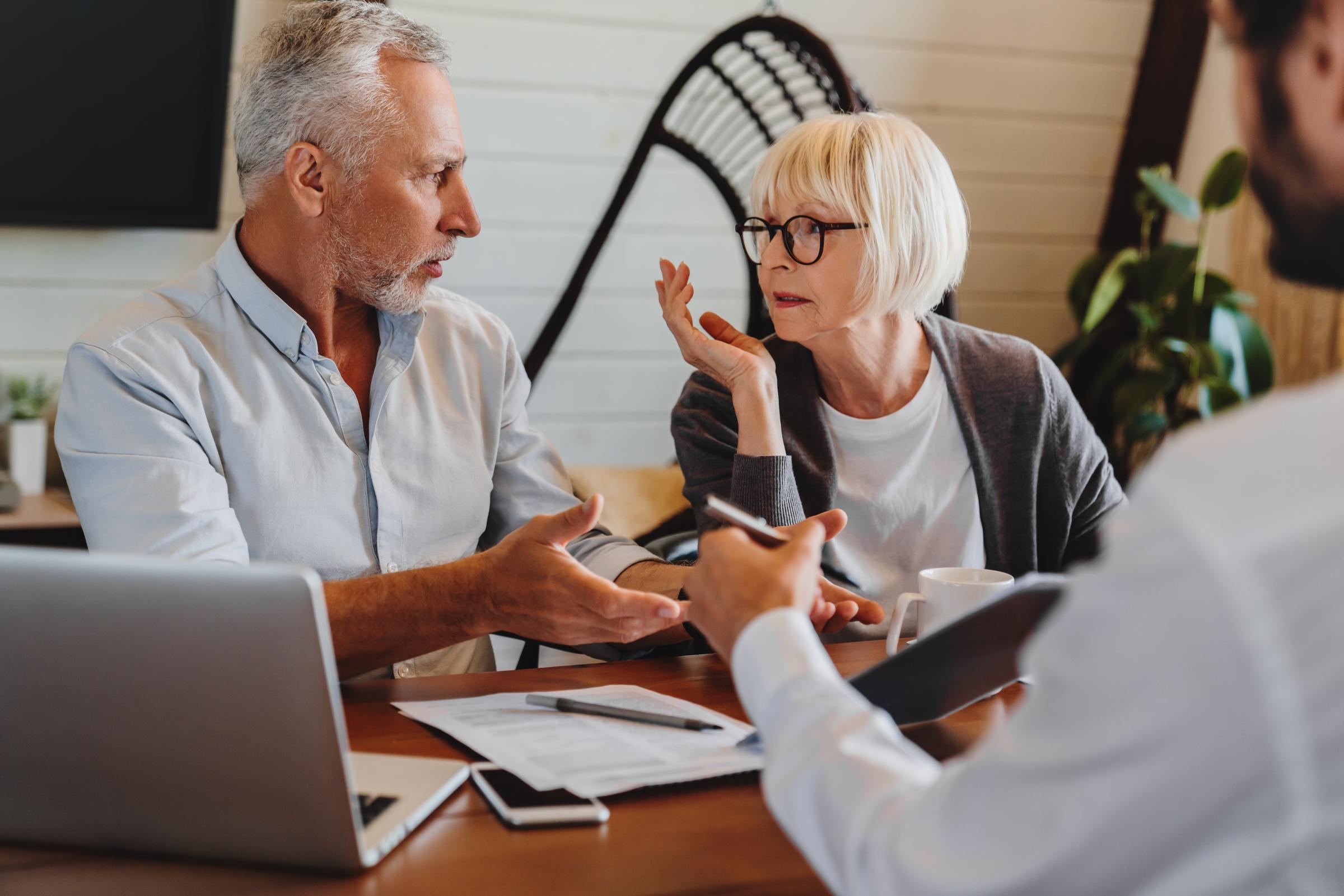 A senior couple discussing over financial paperwork | Source: Shutterstock