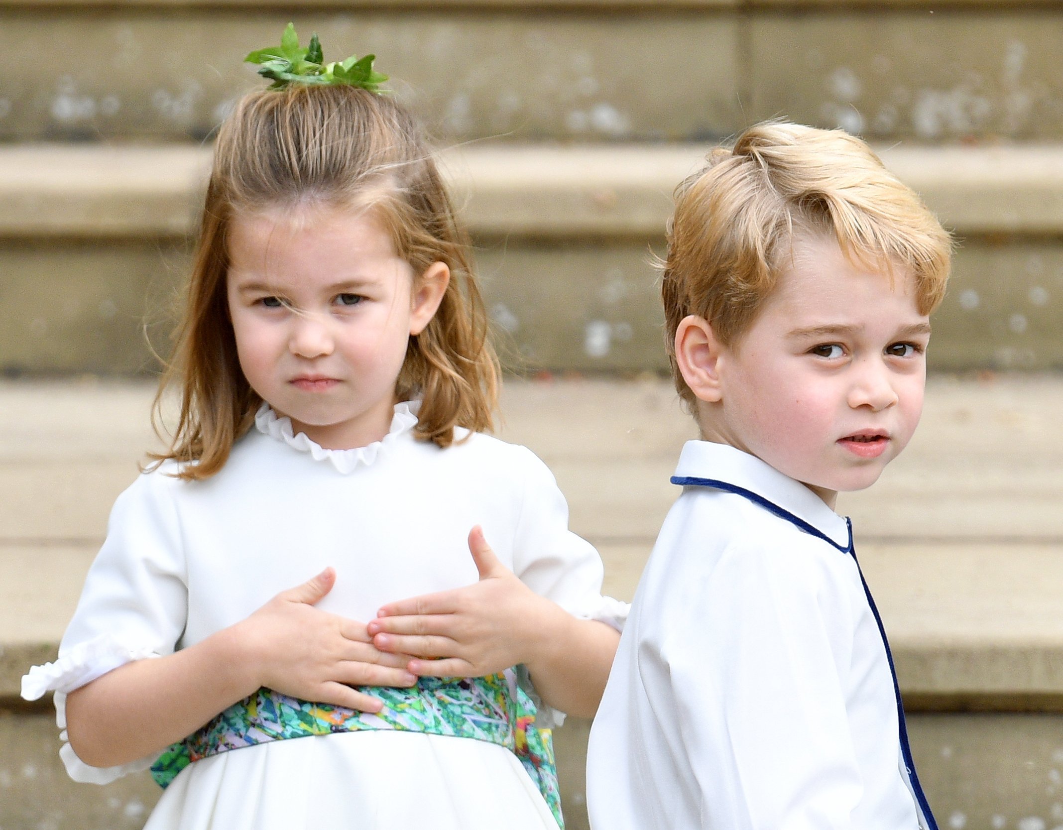 Princess Charlotte and Prince George outside St George's Chapel  at the wedding of Princess Eugenie and Jack Brooksbank | Photo: Getty Images