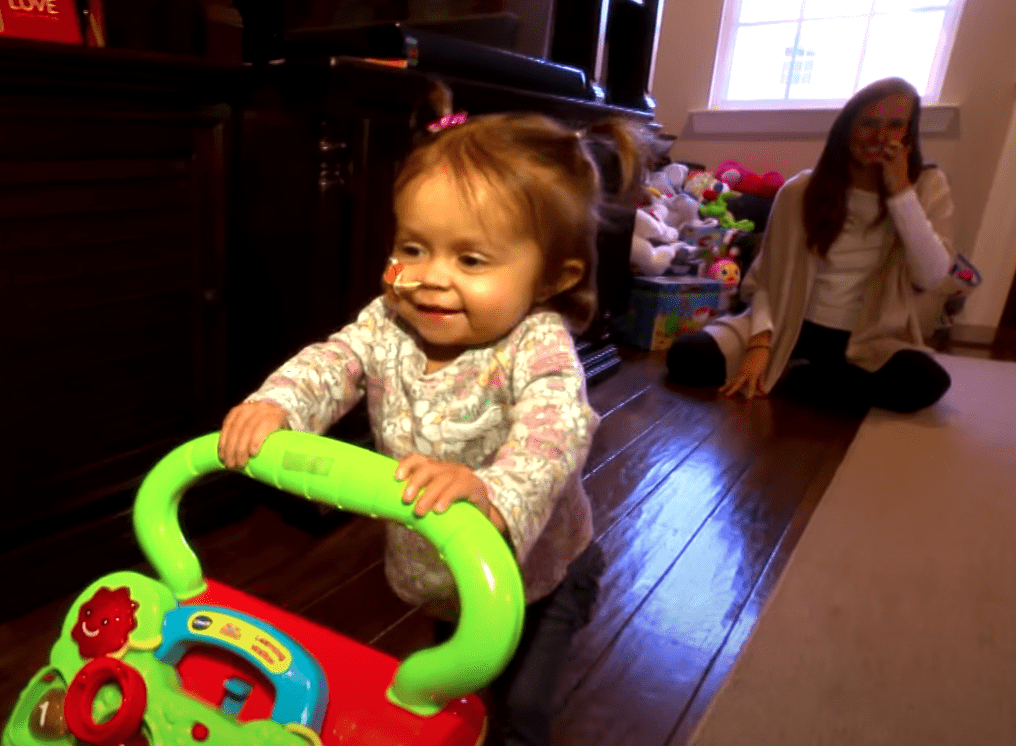 A young child plays with her nanny who donated part of her liver to save her | Photo: Youtube/PIX11 News