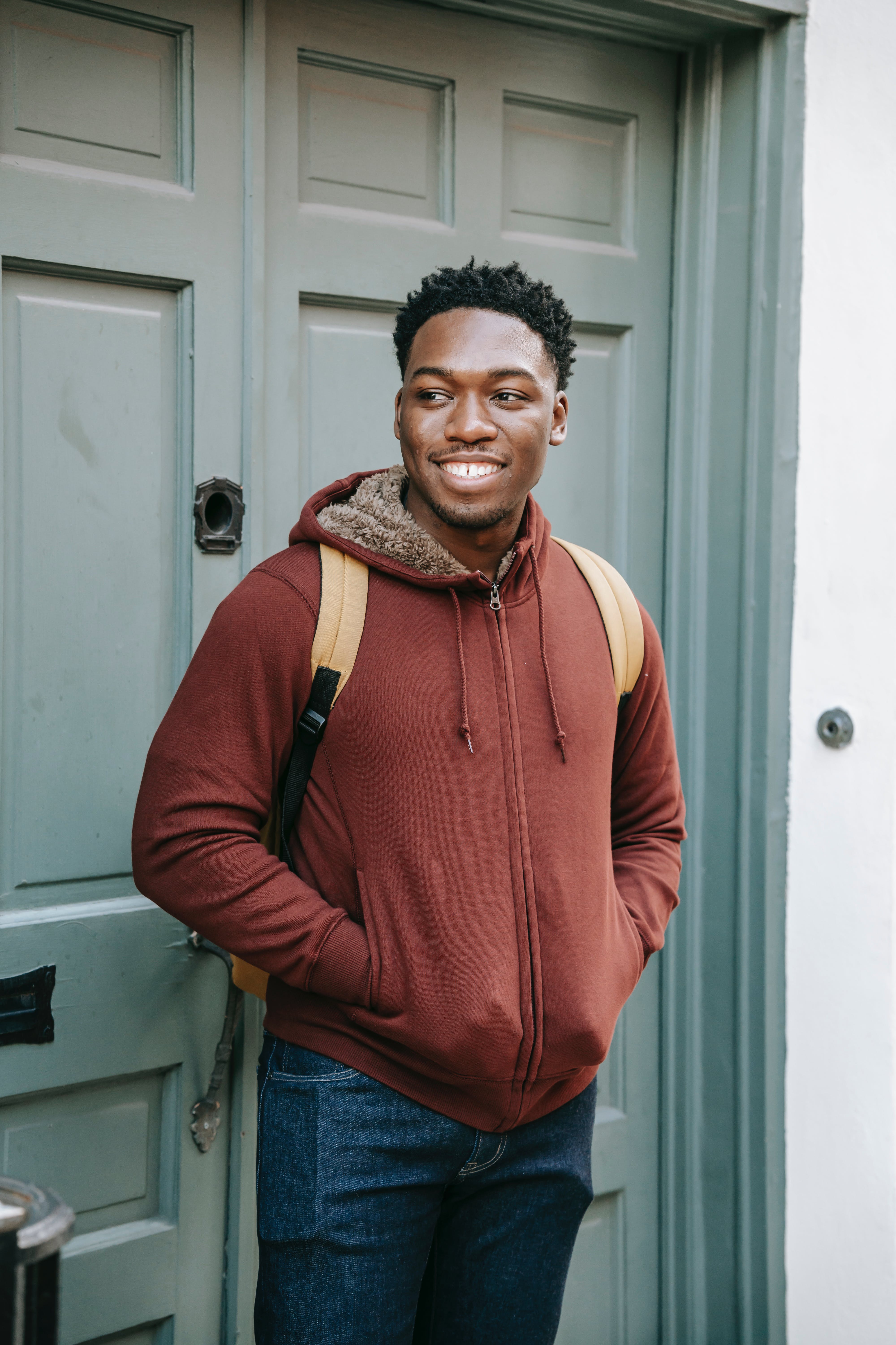 A person standing next to a door. | Source:  Pexels