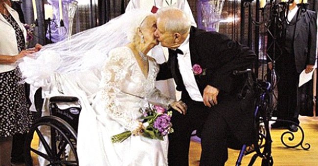 Newlyweds Dana and Bill Stauss kissing on their wedding day. │Source: facebook.com/ExploreTalent
