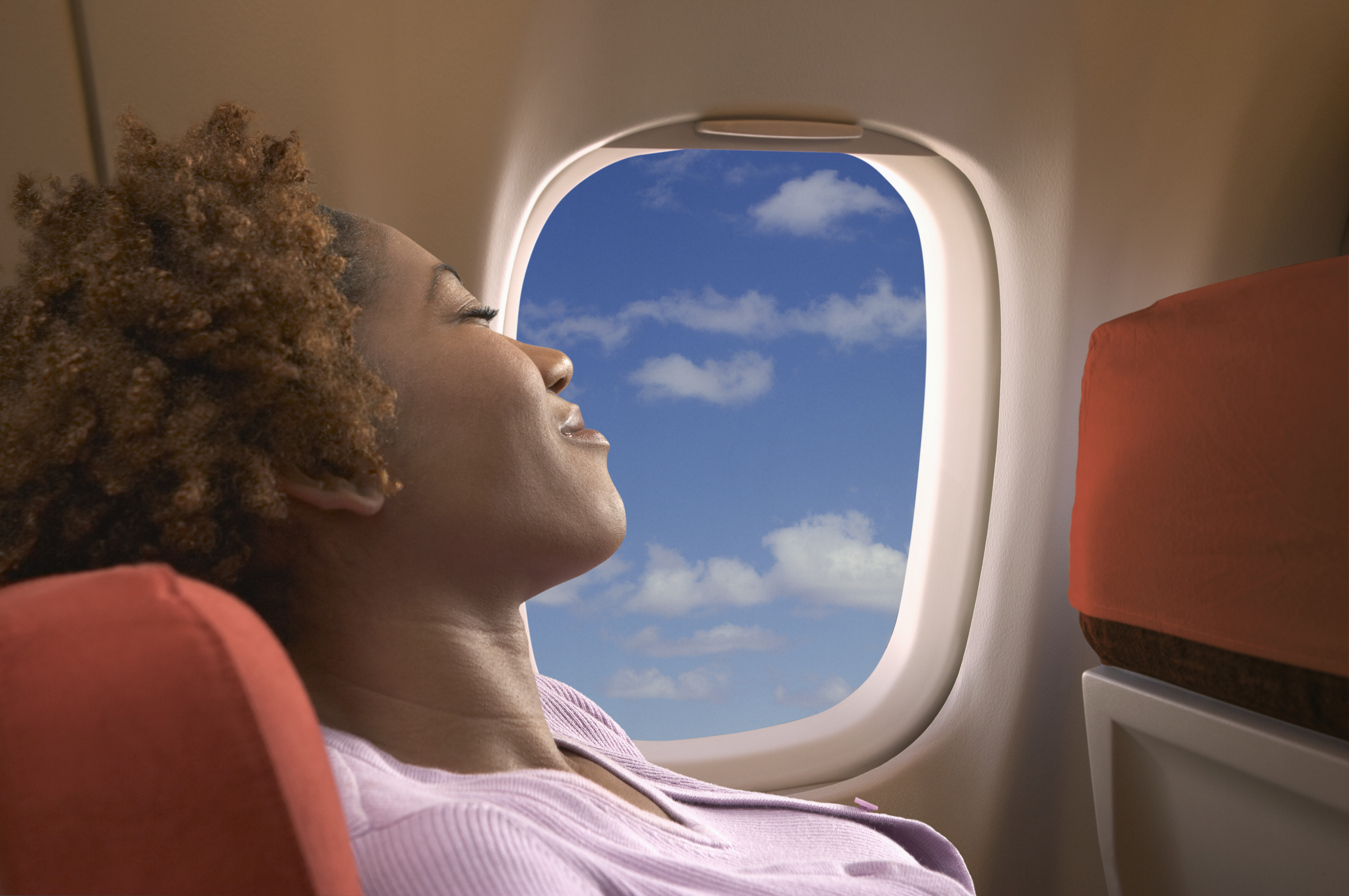 A woman relaxing on an airplane | Source: Getty Images
