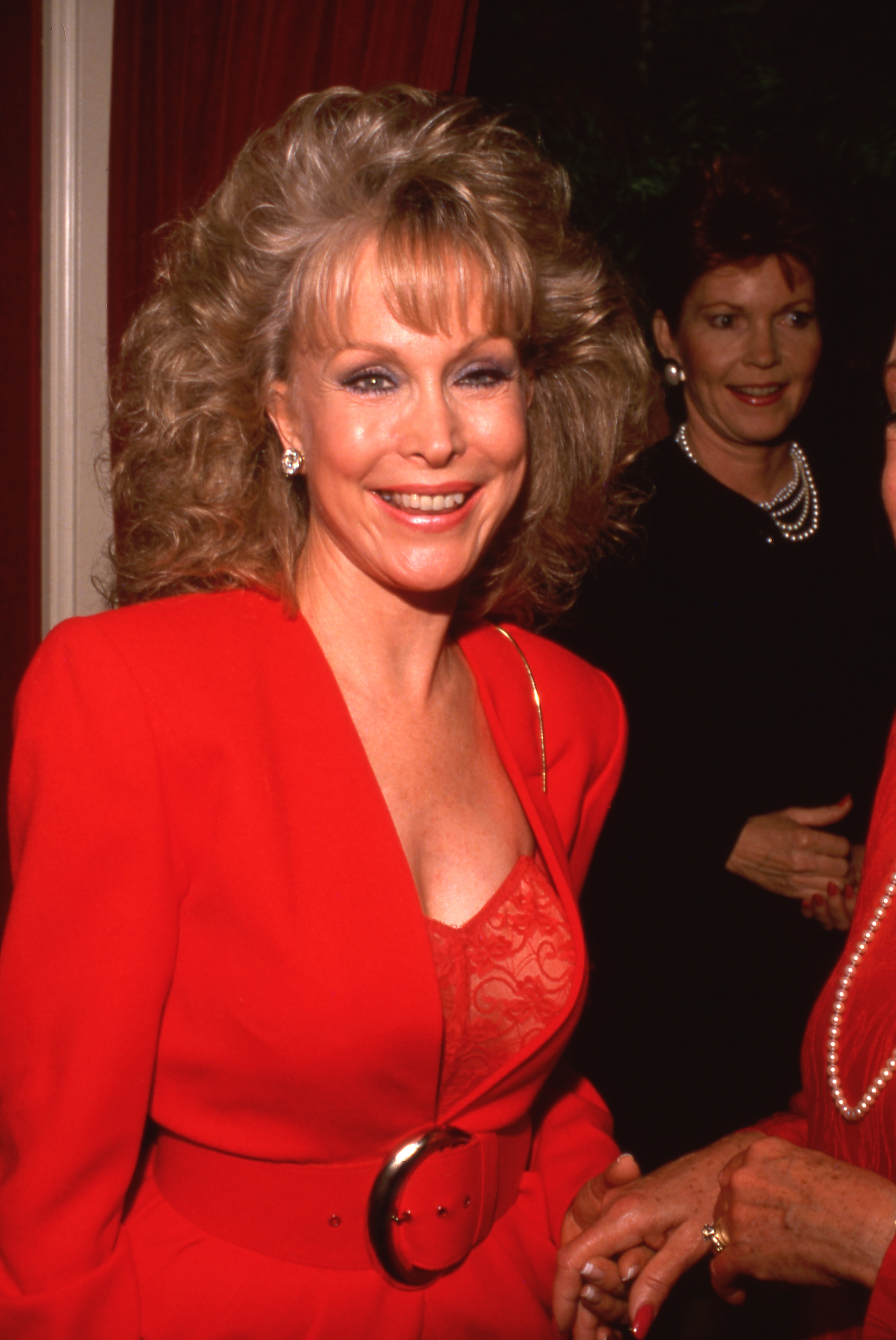 Barbara Eden wears a red suit with a lace top as she attends a party in 1980. | Source: Getty Images