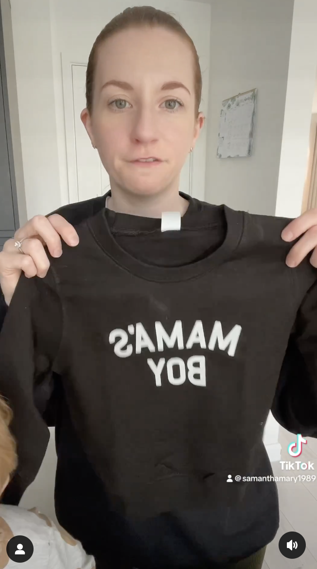Samantha Mary holding a black t-shirt in a video dated September 23, 2023 | Source: instagram.com/samanthamary1989