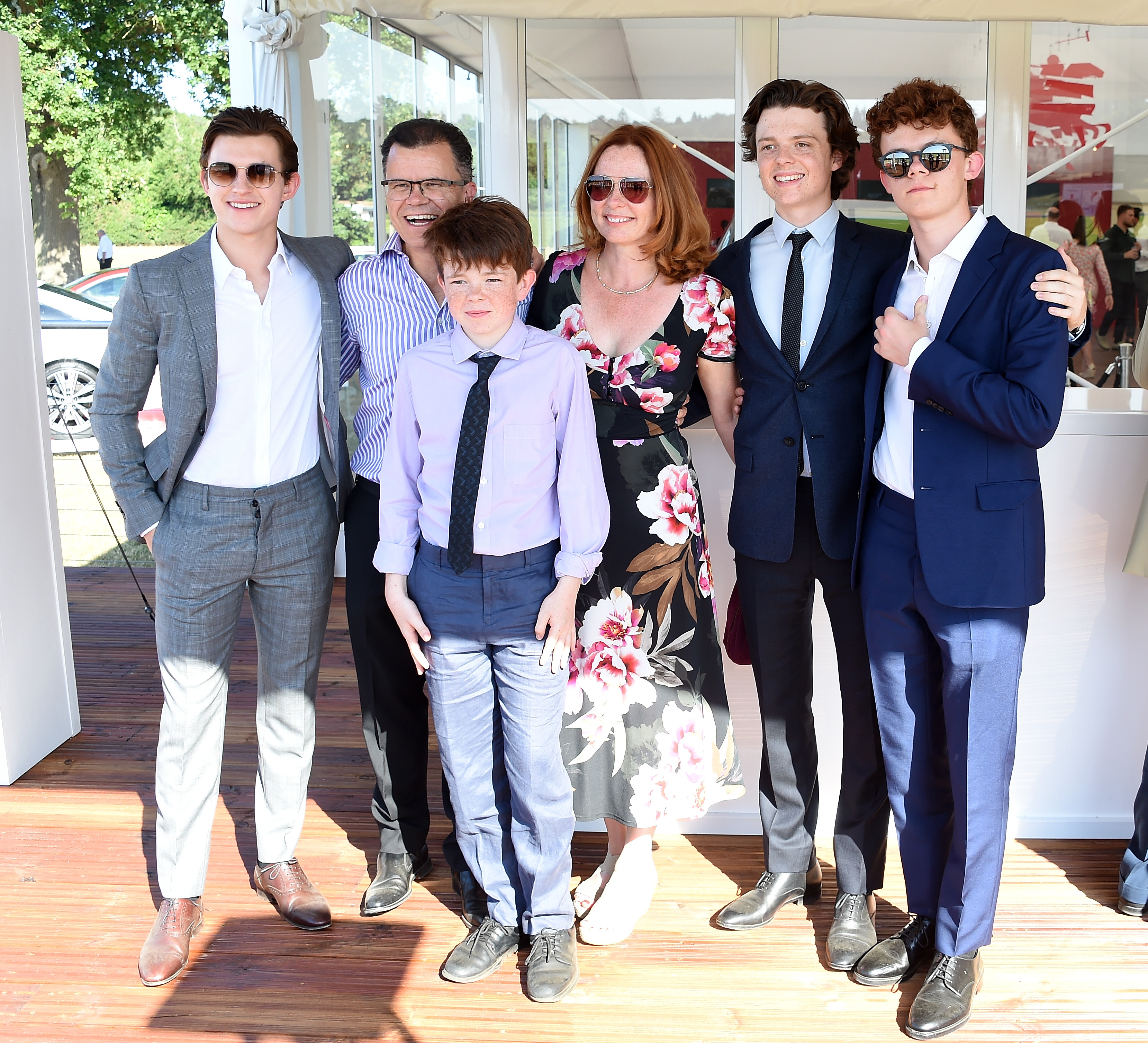 Tom, Harry, Sam and Paddy Holland posing with their parents Dominic and Nicola Holland at the Audi Polo Challenge on June 30, 2018, in Ascot, England. | Source: Getty Images