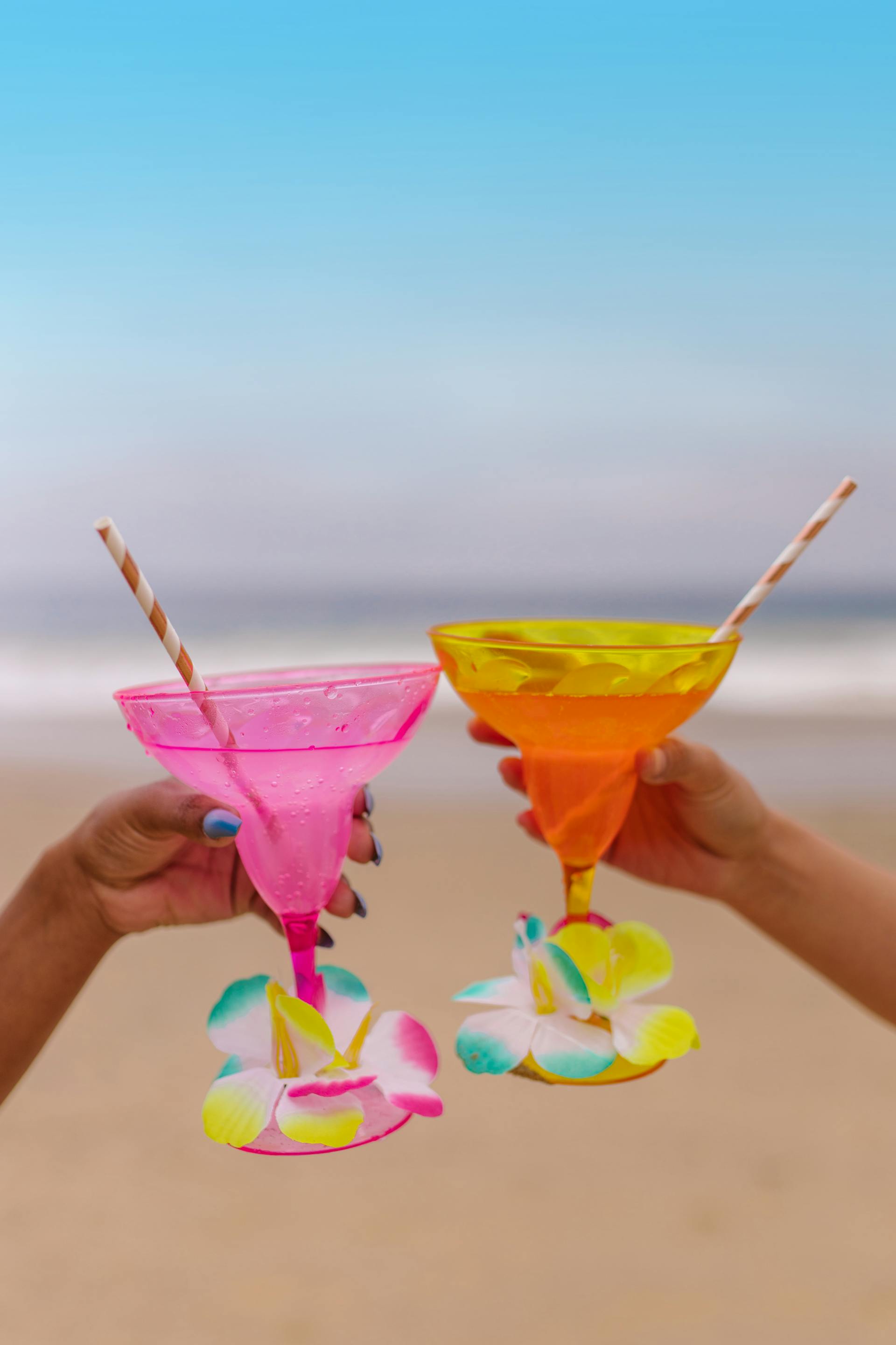 People holding drinks at the beach | Source: Pexels