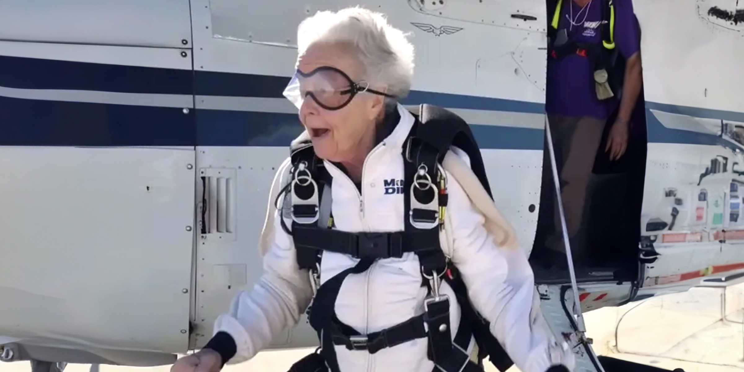 An older woman in skydiving gear | Source: Midjourney