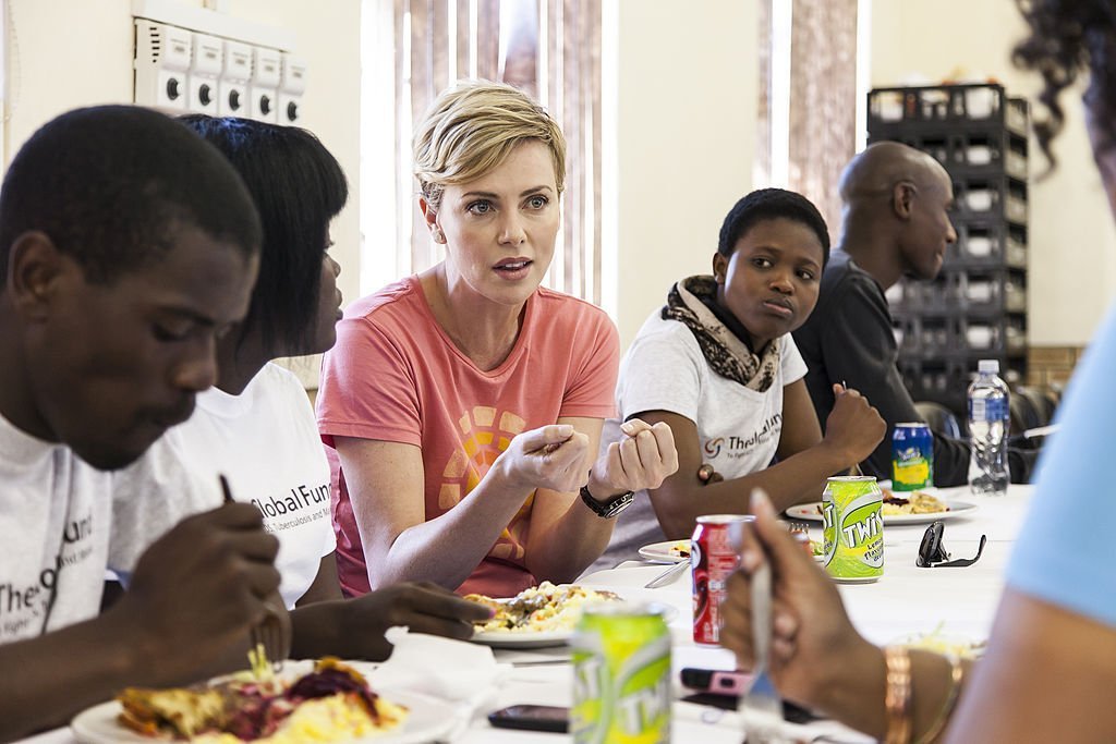 Charlize Theron visiting a Youth Ambassador Project funded by the Global Fund to Fight Aids in August 2013. | Photo: Getty Images