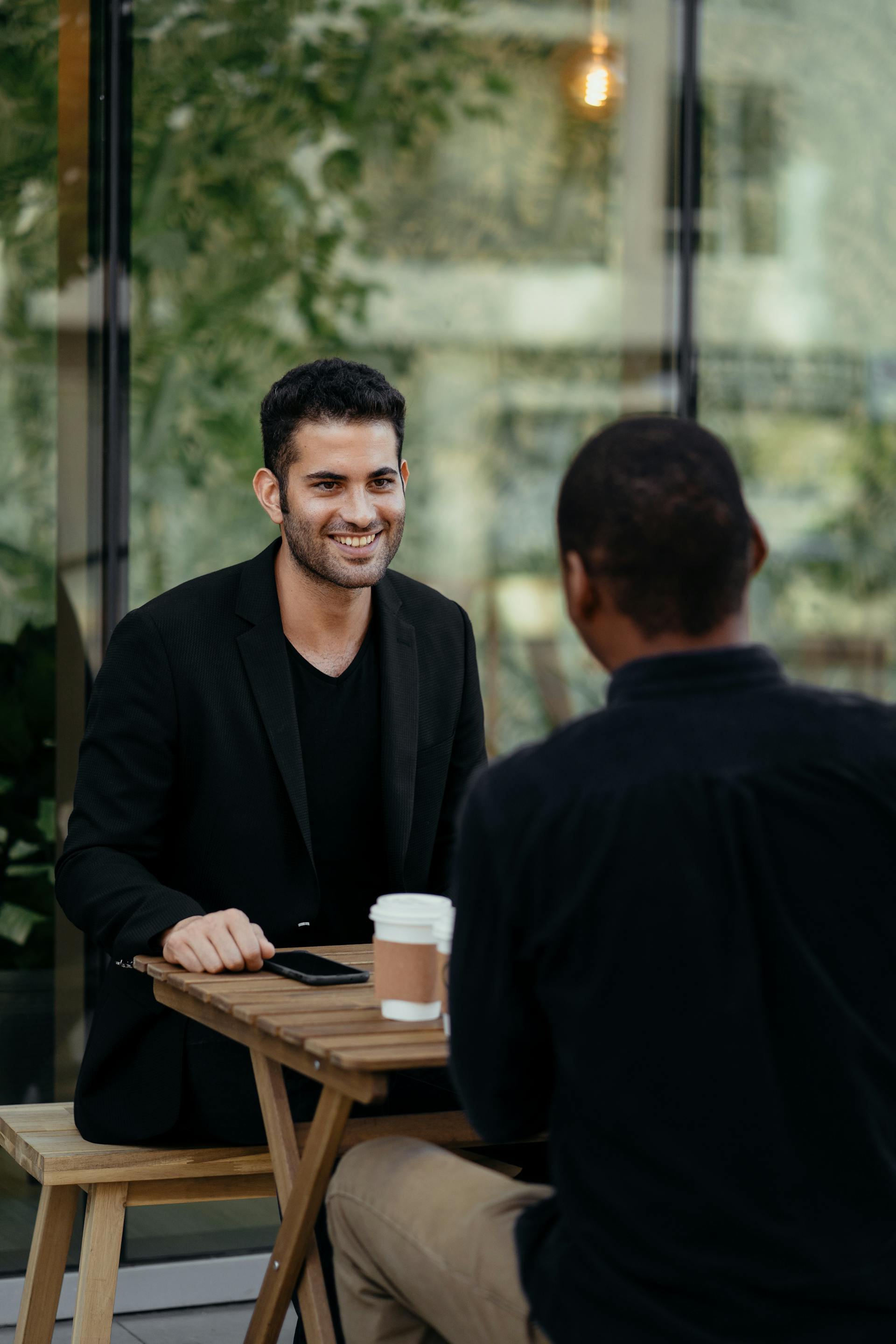 Two men drinking coffee | Source: Pexels