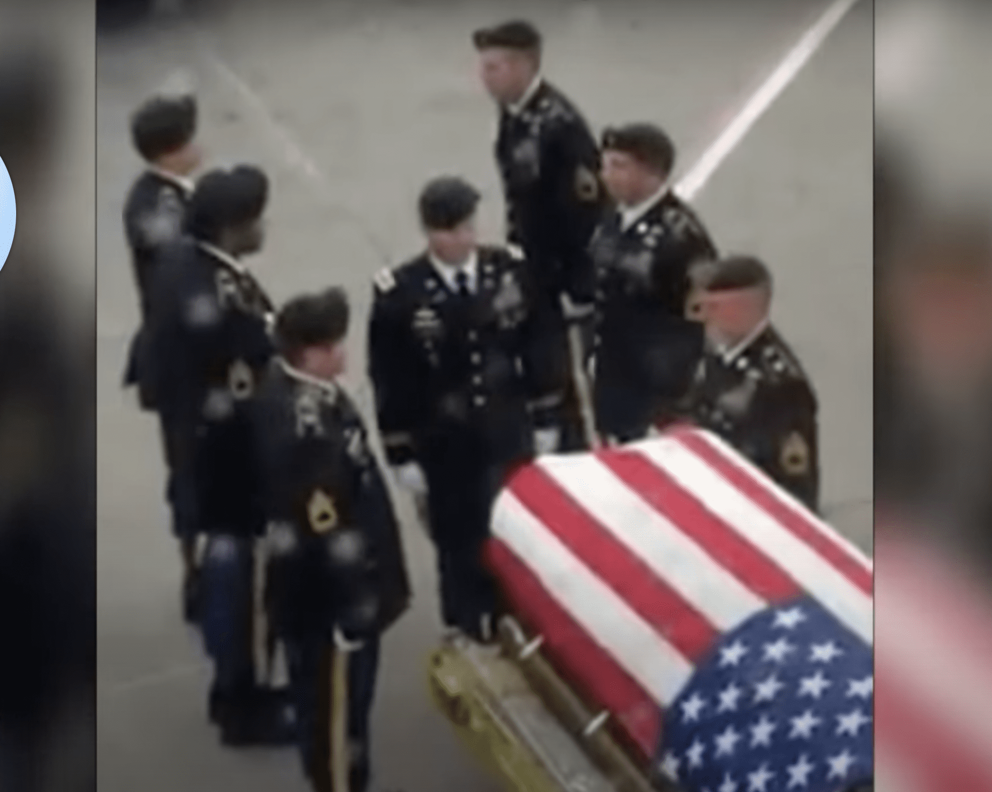 Soldiers are pictured standing next to the flag-draped coffin. | Source: YouTube.com/Inside Edition