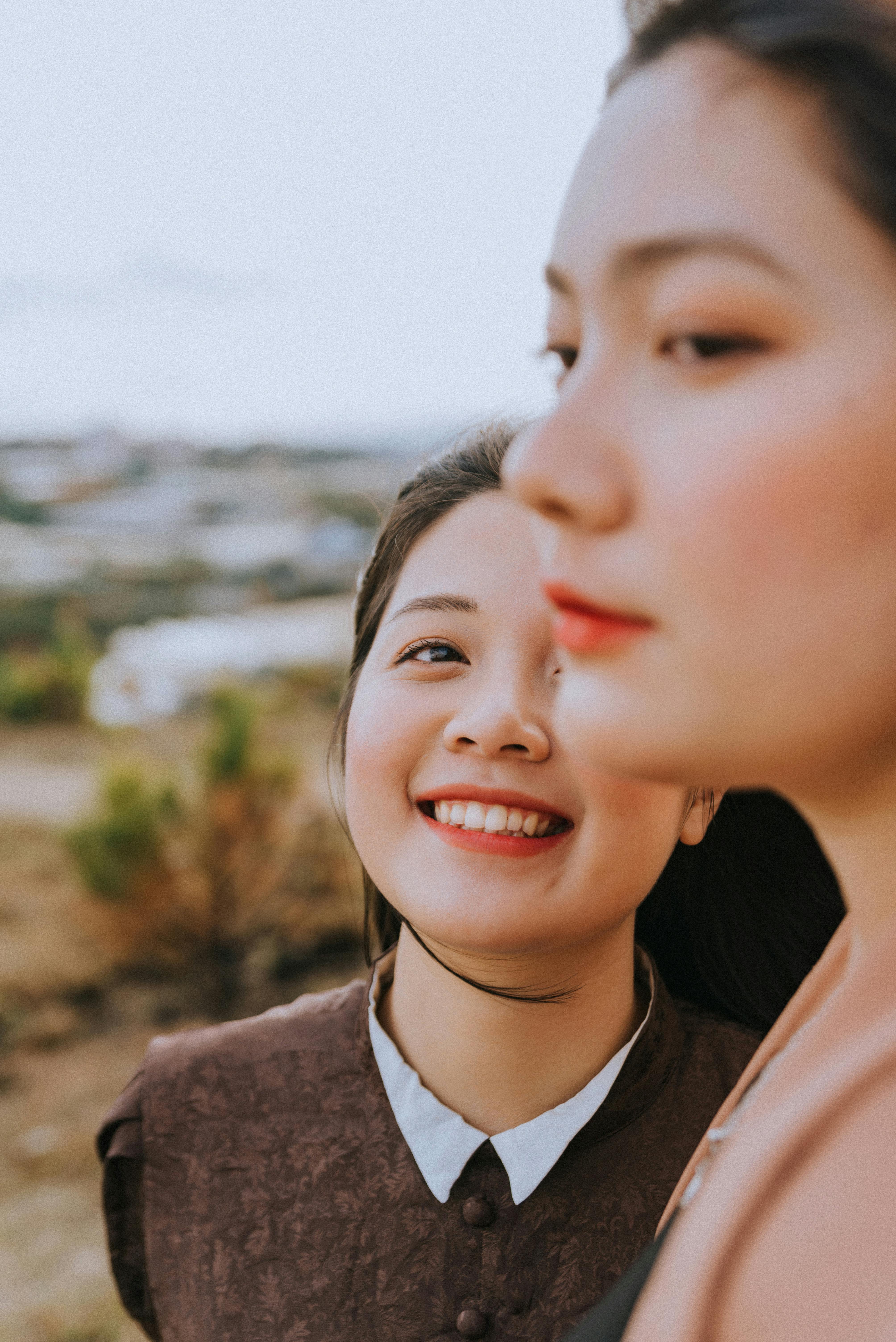 A woman smiling while looking at another woman | Source: Pexels
