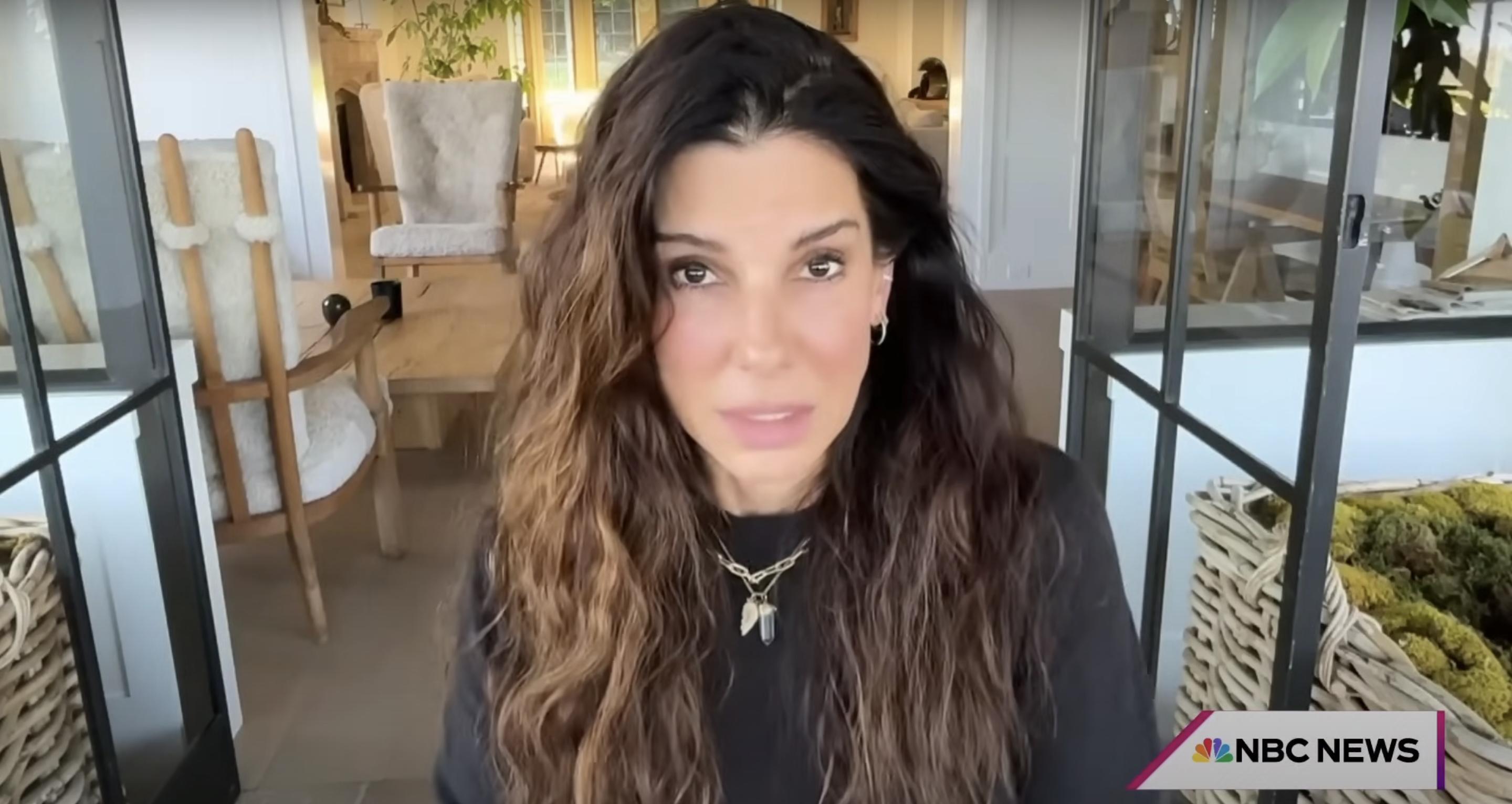 A screenshot of Sandra Bullock speaking in a video posted on August Aug 12, 2024 | Source: YouTube/@HodaAndJenna