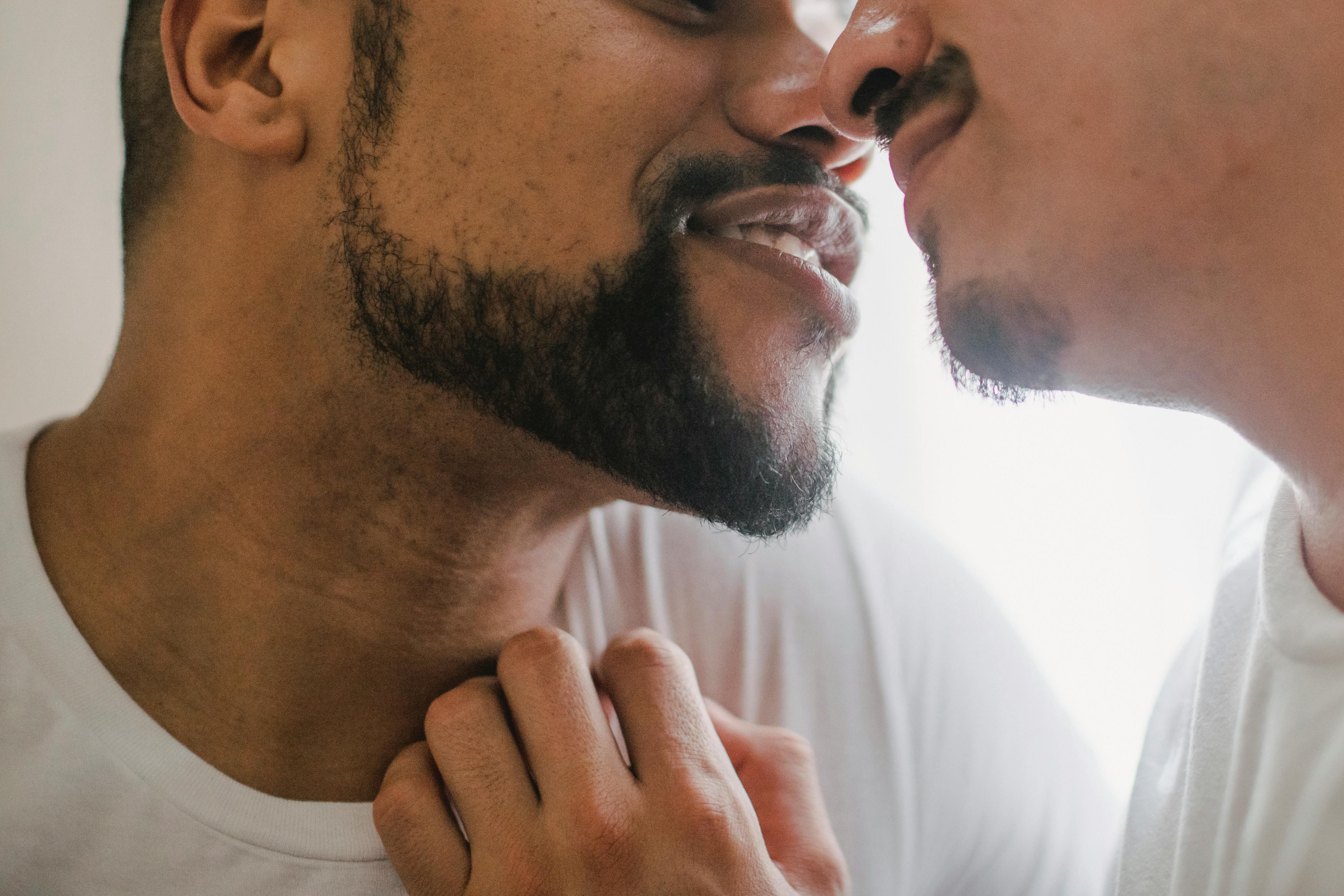 Two men pictured while about to kiss | Source: Pexels