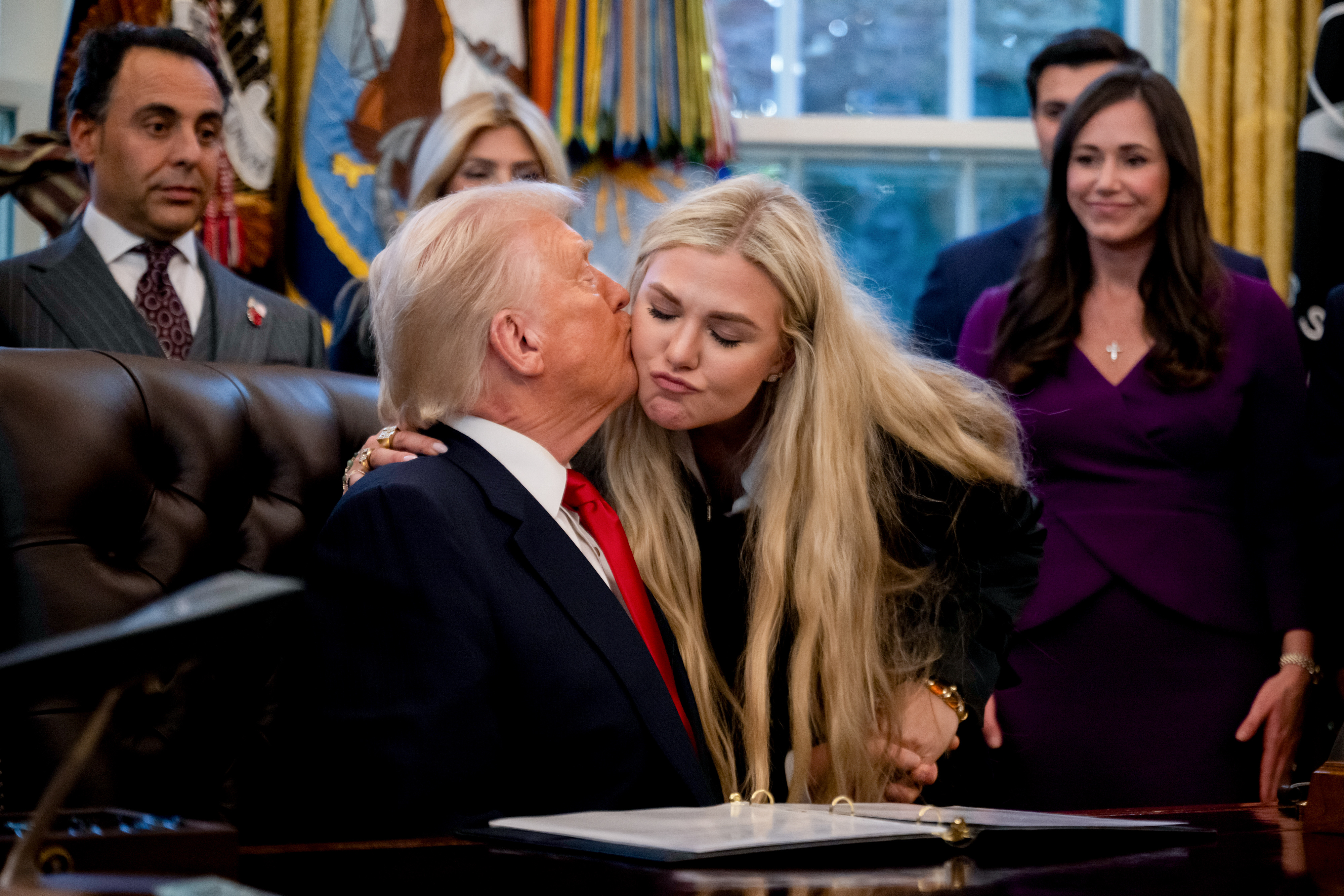 US President Donald Trump and Erika Kirk share a kiss during the swearing-in ceremony in the Oval Office of the White House on November 10, 2025, in Washington, DC | Source: Getty Images