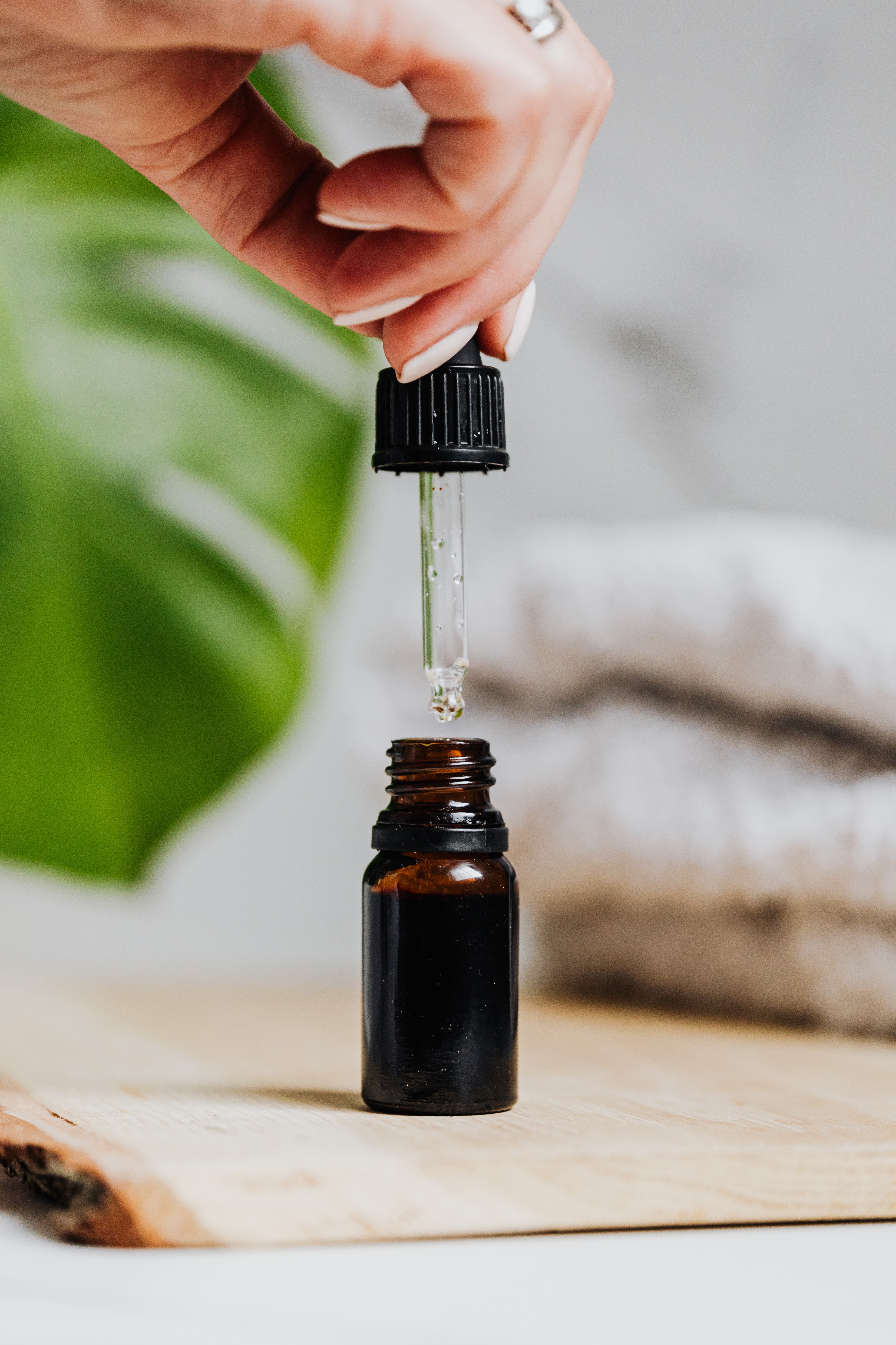 A bottle of oil featuring a woman's nails. | Source: Pexels