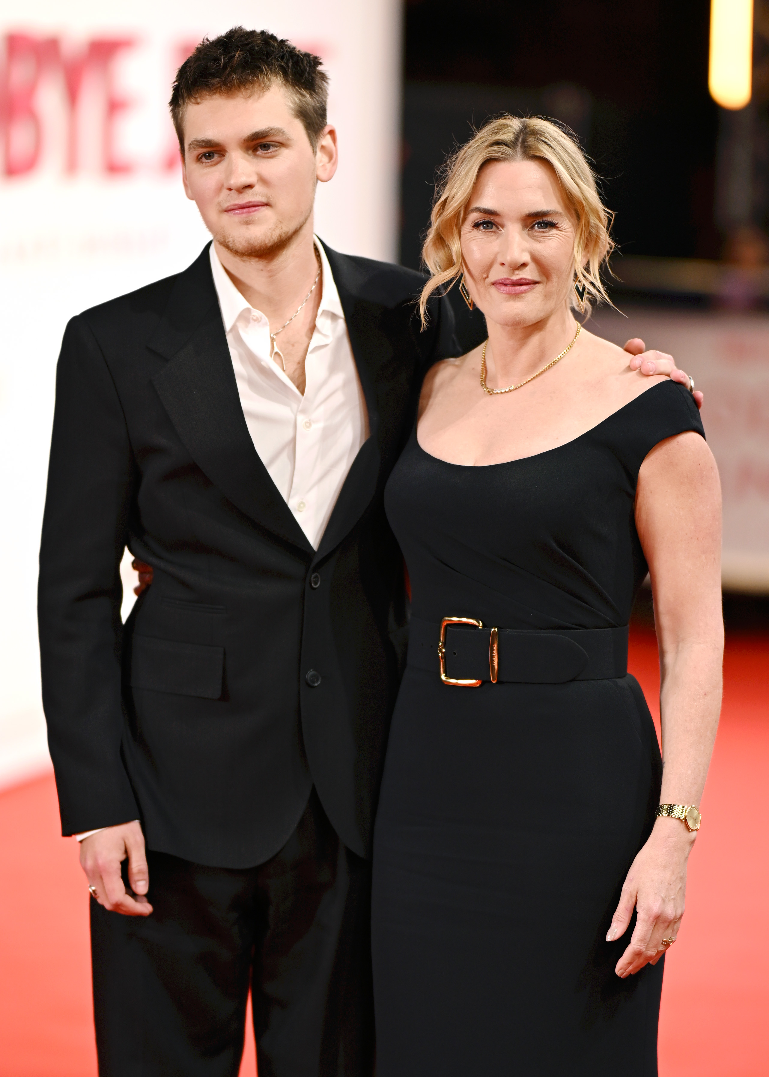 Standing side by side under the bright premiere lights, Winslet and Anders posed for photographers with calm confidence. The actress, in a sleek belted black gown, and Anders, in a tailored dark suit and open-collared shirt, looked every bit the poised creative team behind "Goodbye June."