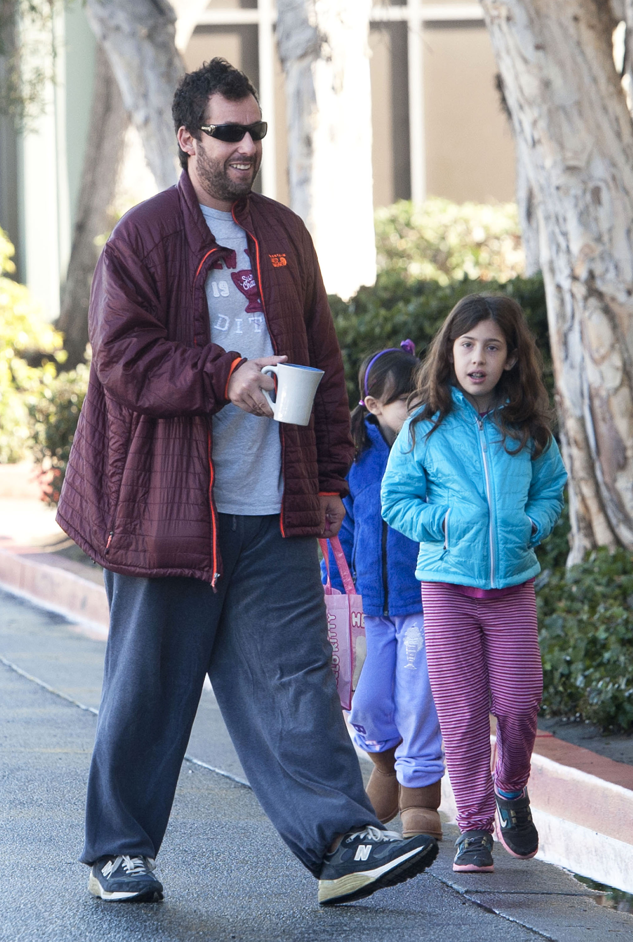 Adam Sandler was spotted in Los Angeles taking his daughters, Sadie and Sunny, to dance class. True to his laid-back style, he wore his signature baggy casuals, while his girls matched the cozy vibe in jackets, pants, and sturdy shoes.
