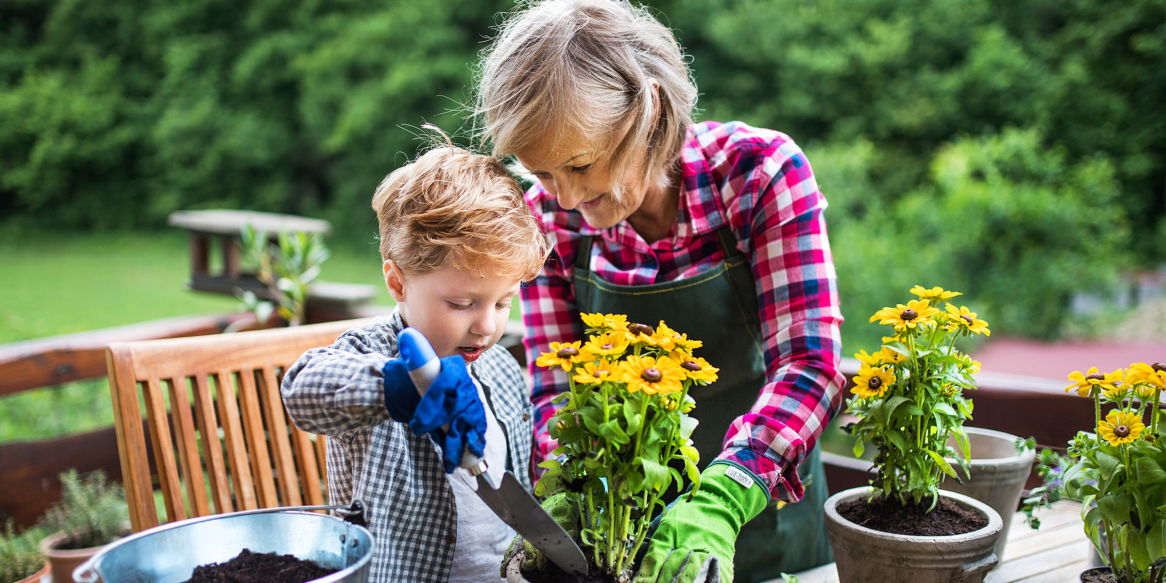 An elderly woman and a child gardening | Source: Getty Images