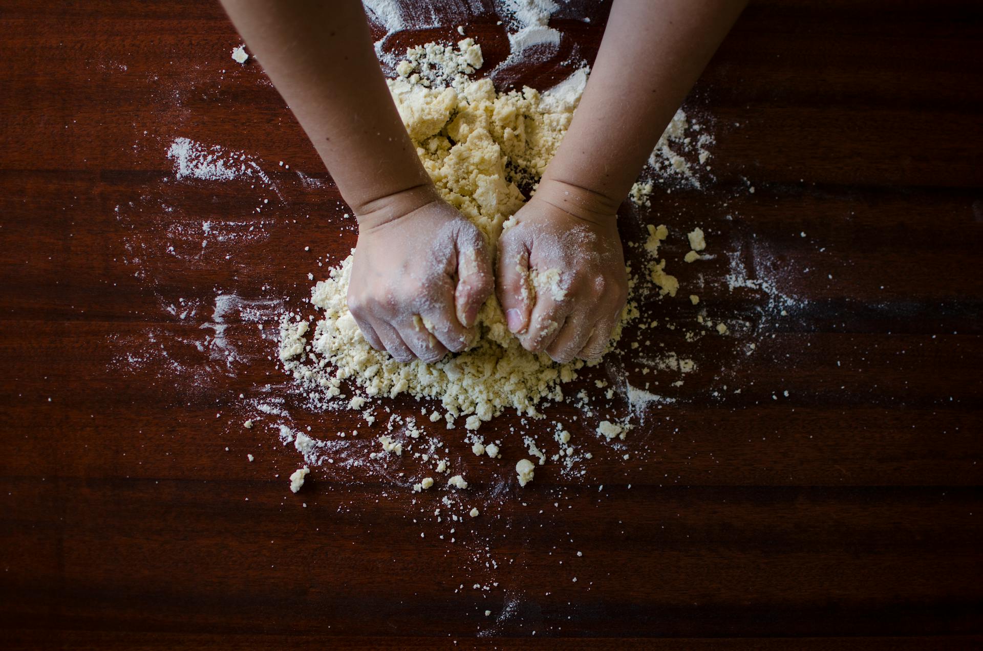 A person kneading dough | Source: Pexels