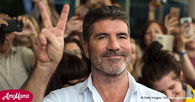 Simon Cowell proudly shows off his adorable four-year-old son while receiving Hollywood star