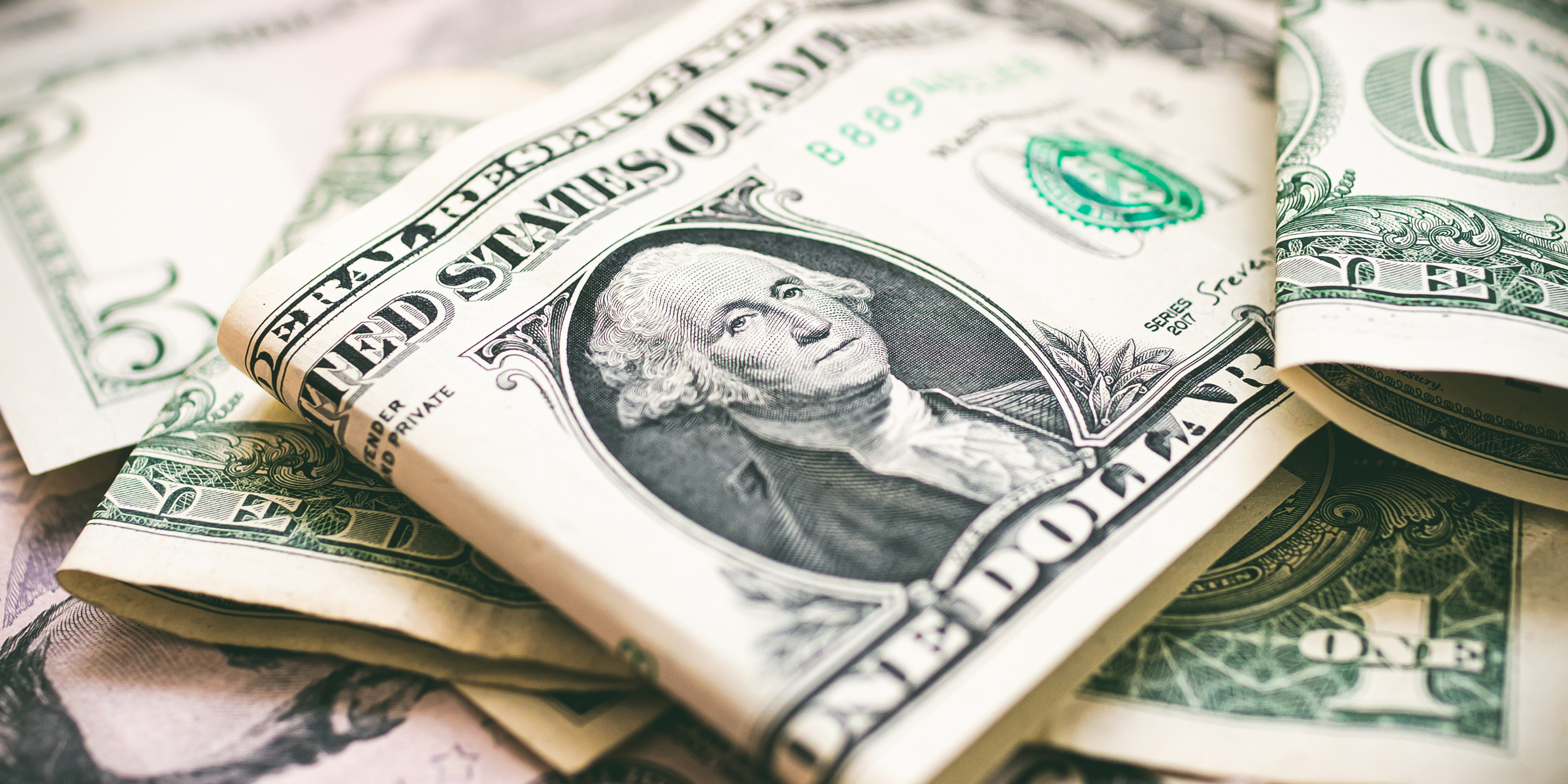 Folded dollar bills | Source: Shutterstock