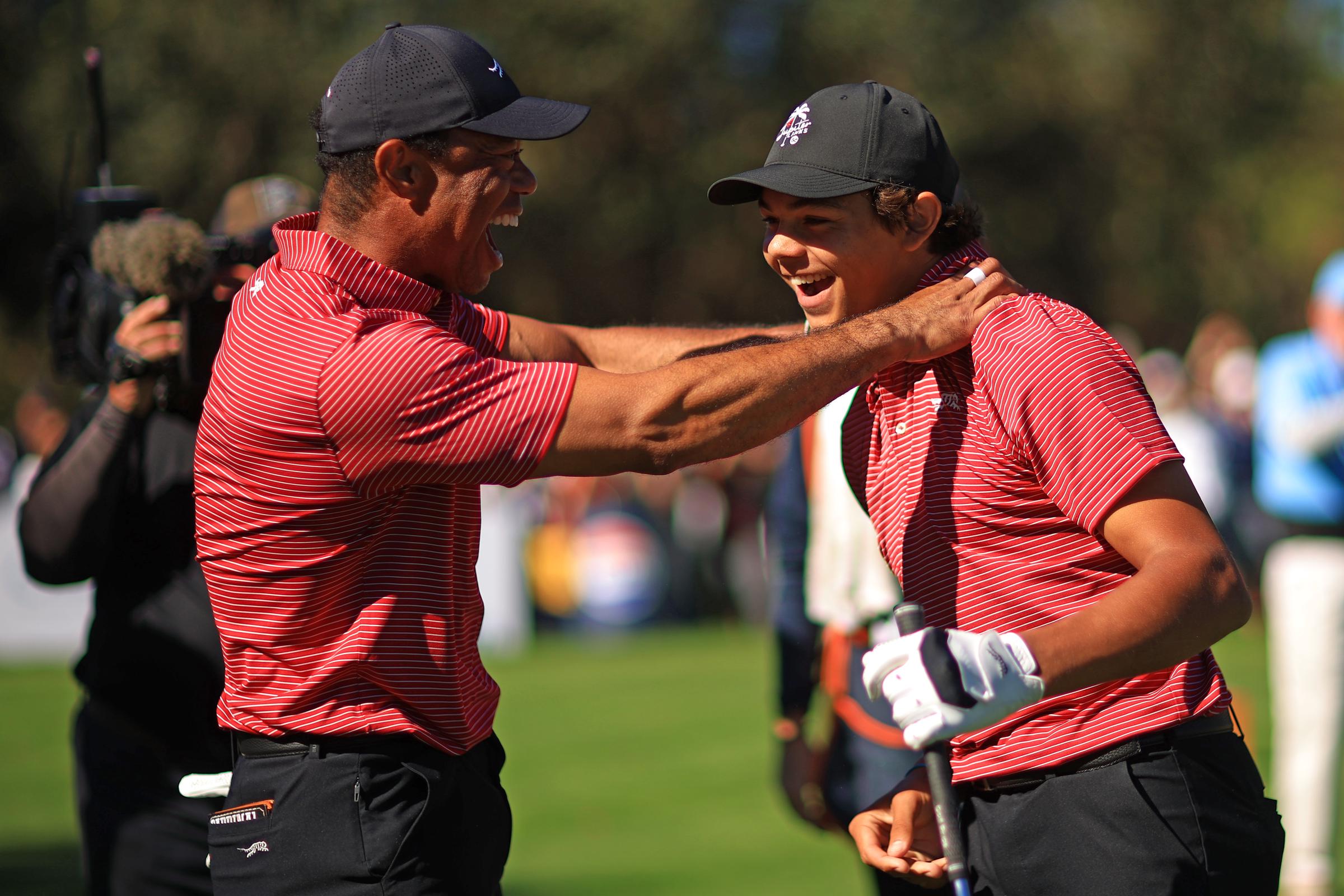 Tiger Woods reacts with Charlie Woods after making the first hole-in-one of his career on the fourth hole during the second round of the PNC Championship | Source: Getty Images