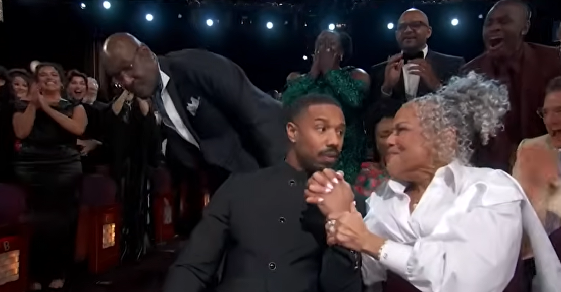 Donna Jordan reaches for her son’s hand and squeezes it tightly, her face glowing with emotion as Michael B. Jordan looks momentarily stunned beside her. | Source: YouTube/ABCNews