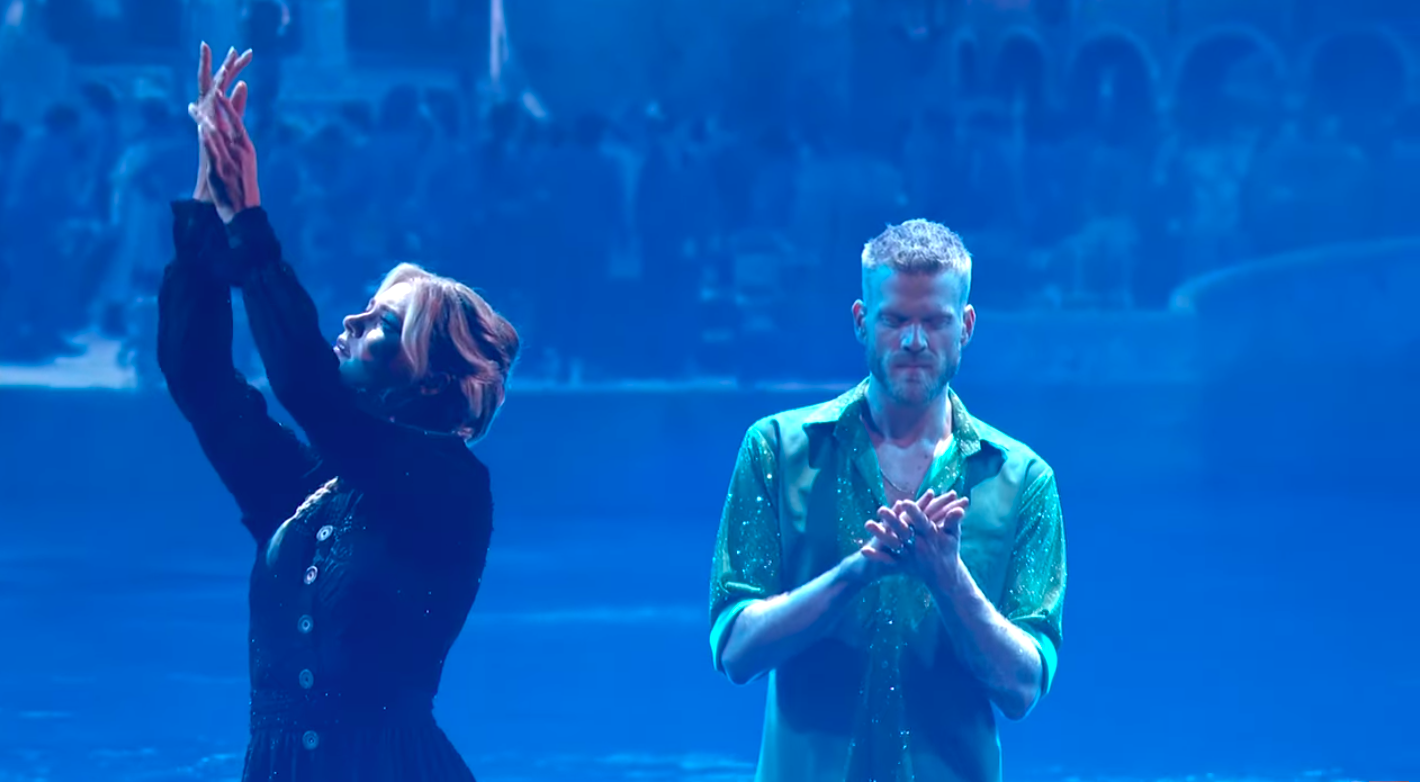 Rylee Arnold executing arm movements as Scott Hoying walks behind her, posted on October 22, 2025. | Source: YouTube/Dancing With The Stars