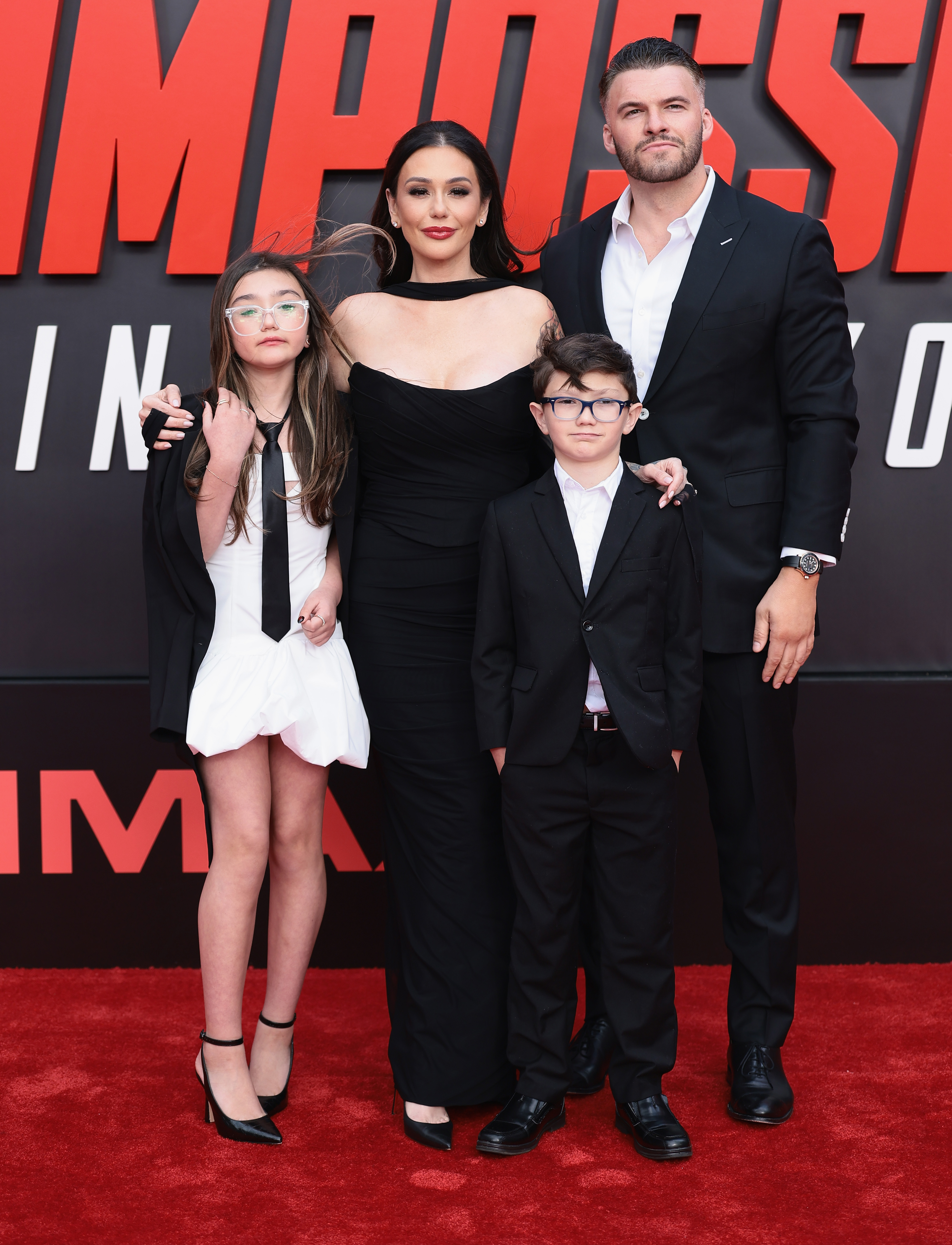 Jenni's two children, Meilani and Greyson, were folded into the ceremony directly. Zack handed his new stepdaughter a ruby birthstone ring. He gave Greyson a soccer-themed gift. | Source: Getty Images