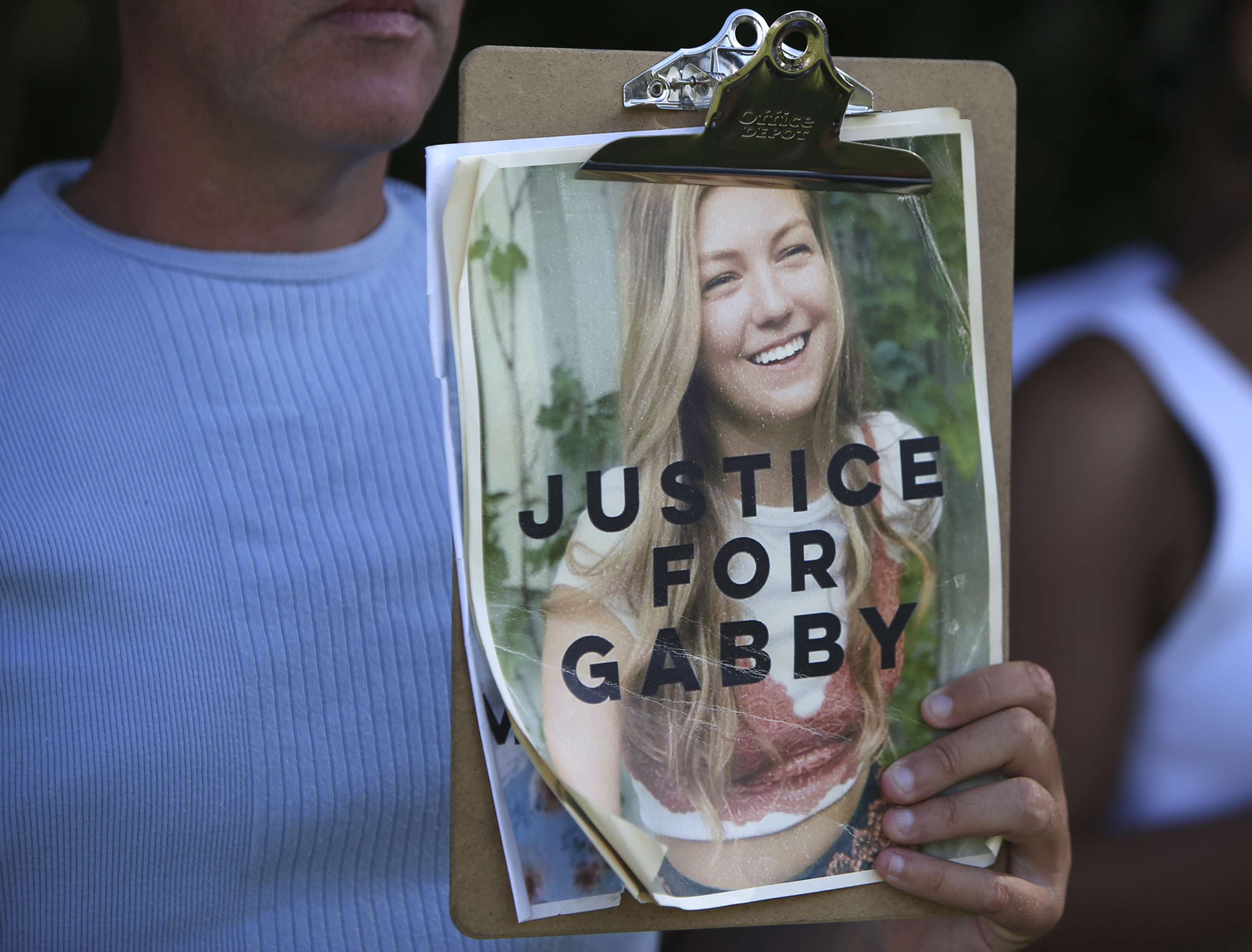 A supporter photographed holding a "Justice for Gabby" sign on October 20, 2021. | Source: Getty Images