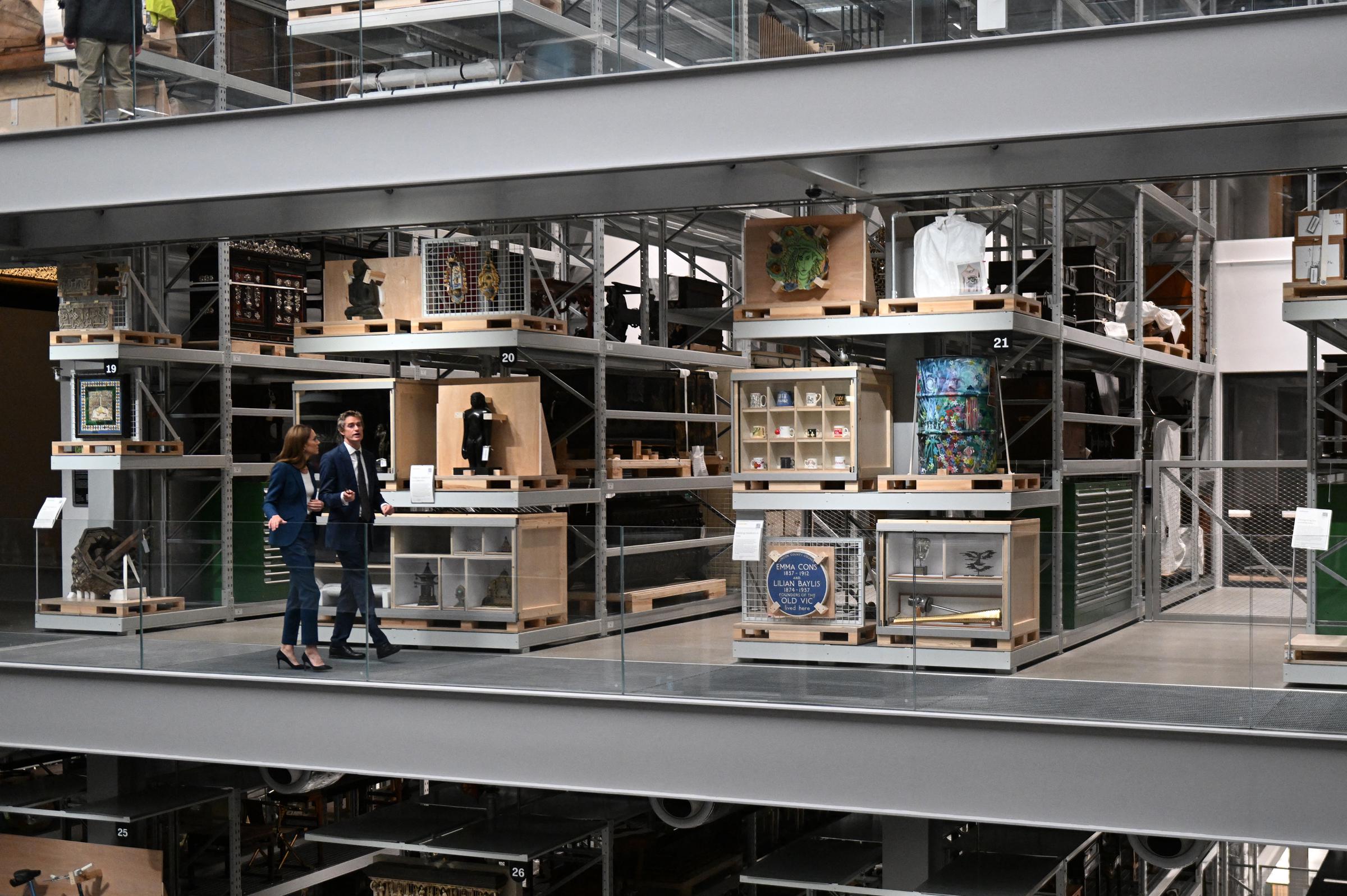 Princess Catherine tours the upper levels of the museum with Tristram Hunt. The two converse while surrounded by archived objects. Her body language is open, and her stride confident as she engages with the venue’s modern layout.