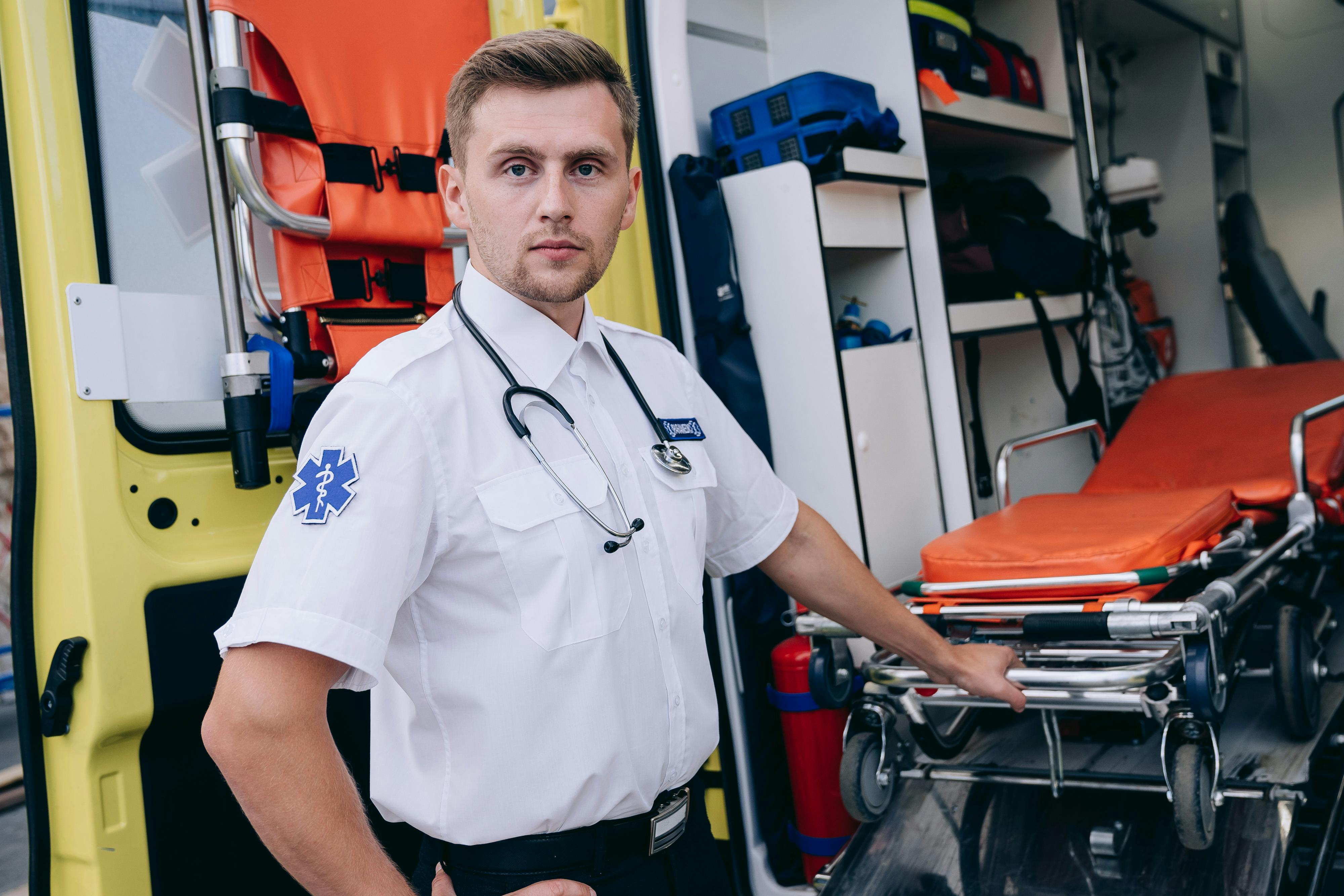 A paramedic pulling out a stretcher from an ambulance | Source: Pexels