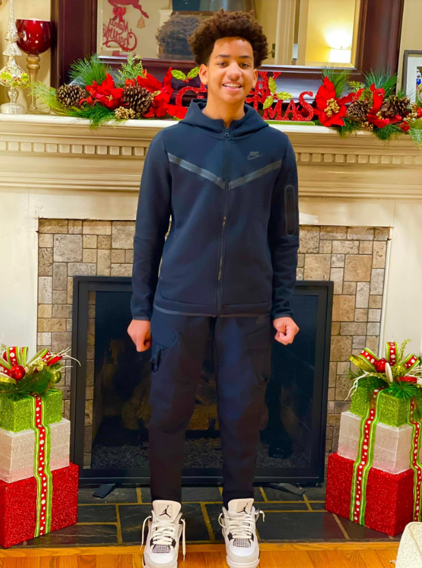 Cameron Fairfax stands in front of a decorated fireplace during a holiday moment | Source: Facebook/justin.fairfax.2025