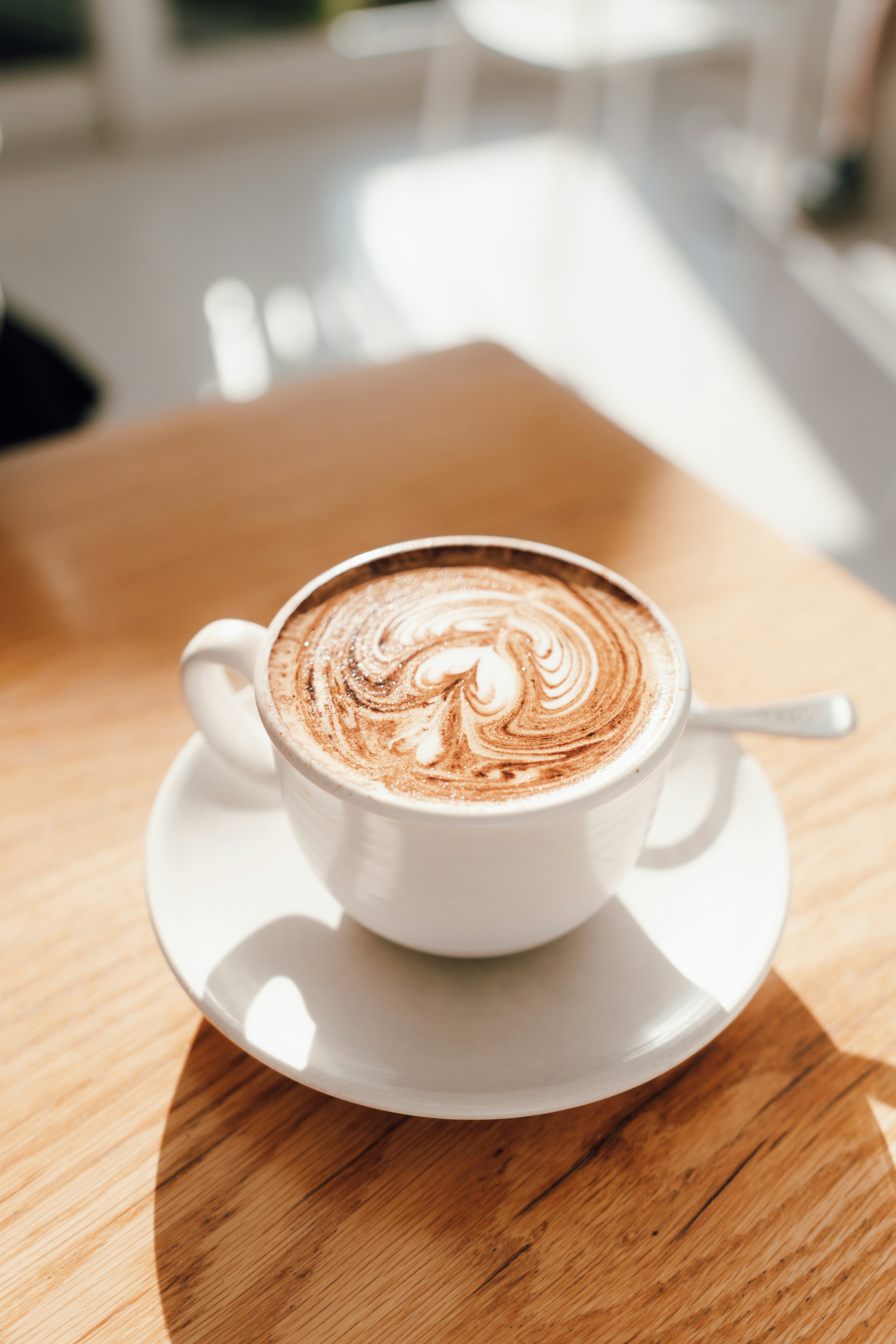 A cup of coffee on a wooden table | Source: Unsplash