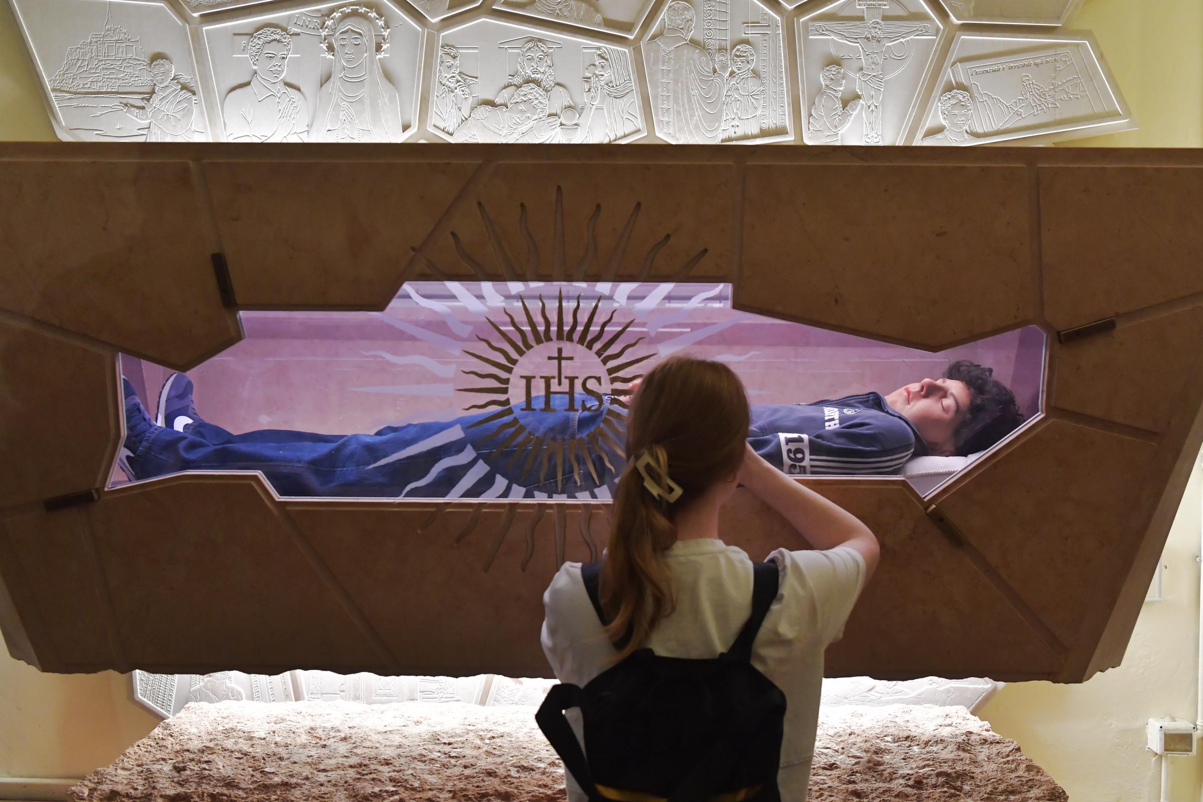 Faithful prays in front of the tomb of Carlo Acutis at Santa Maria Maggiore Sanctuary of the Renunciation on April 23, 2025 in Assisi, Italy | Source: Getty Images
