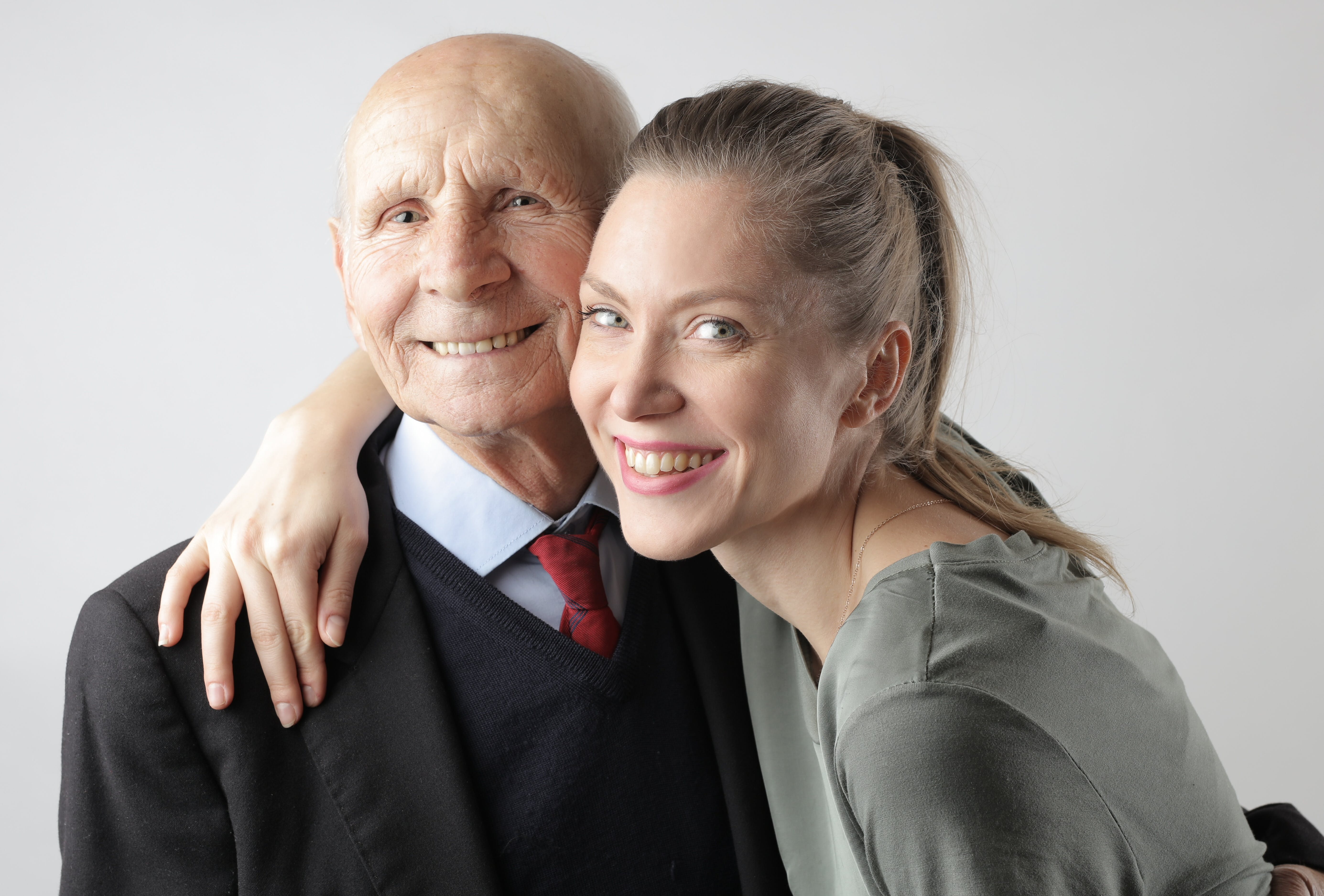 An elderly man and a young woman posing for a portrait | Source: Pexels